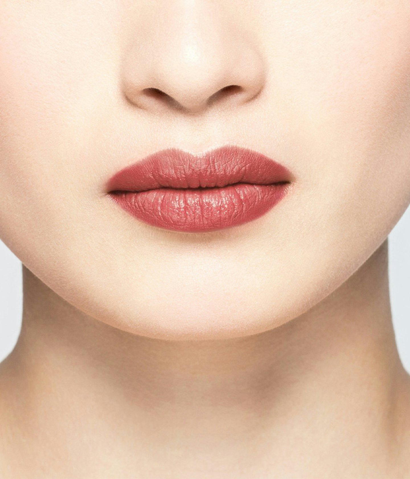 La bouche rouge Nude Brown lipstick shade on the lips of an Asian model