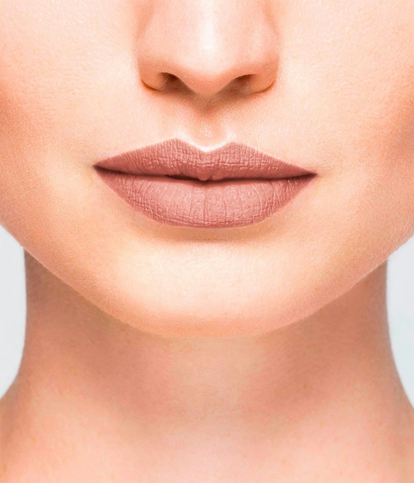 La bouche rouge Nude Brun Matte lipstick shade on the lips of a fair skin model