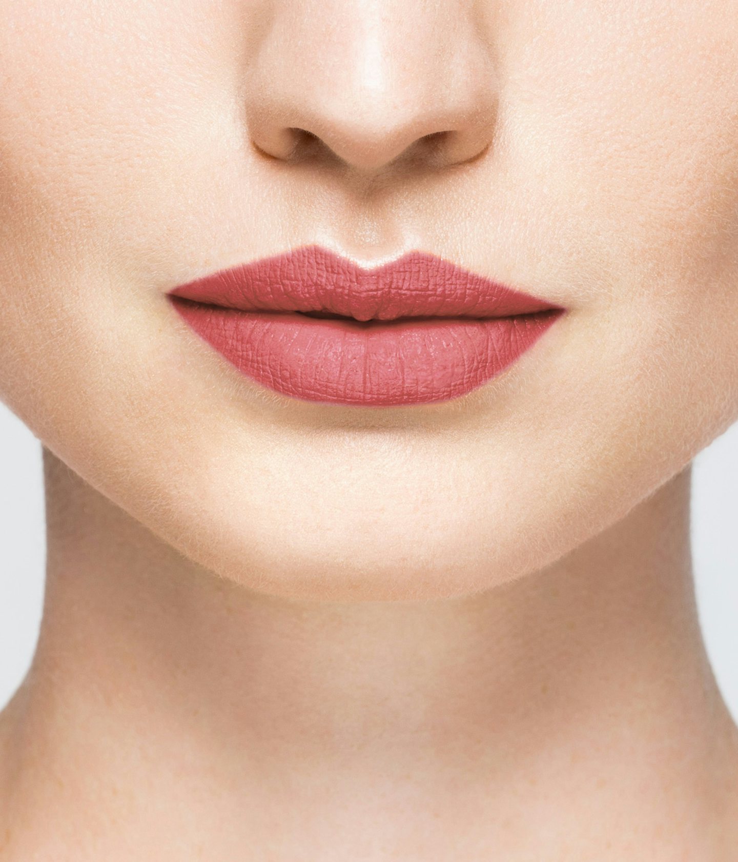 La bouche rouge Cherry Pink lipstick shade on the lips of a fair skin model