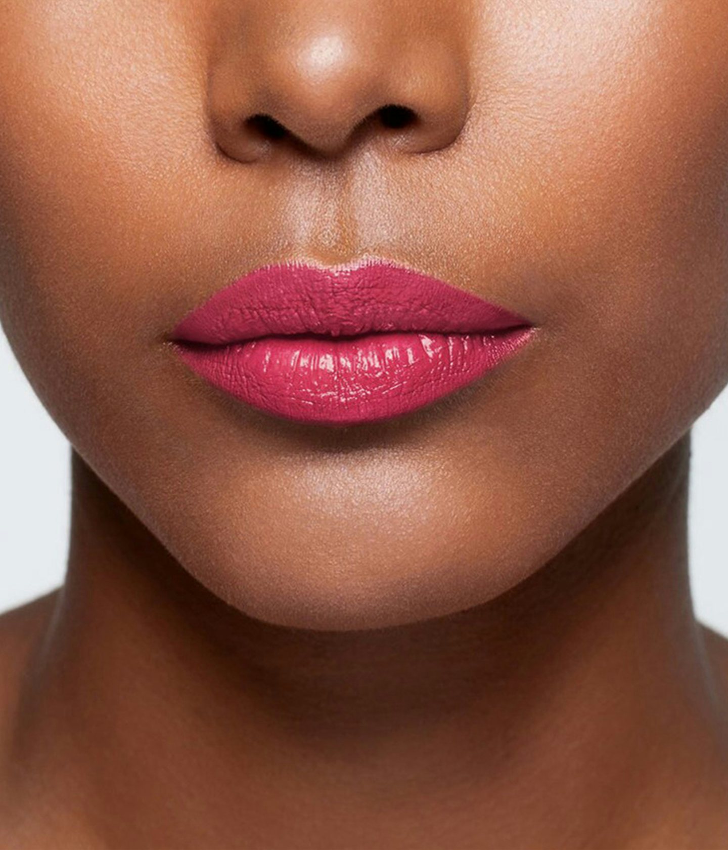 La bouche rouge Innocent Red lipstick shade on the lips of a dark skin model