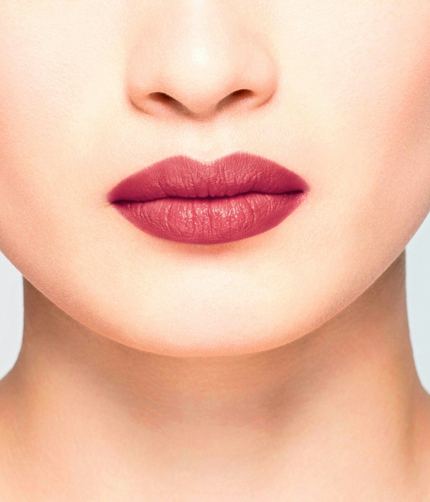 La bouche rouge Le Baume Kelly lipstick shade on the lips of an Asian model