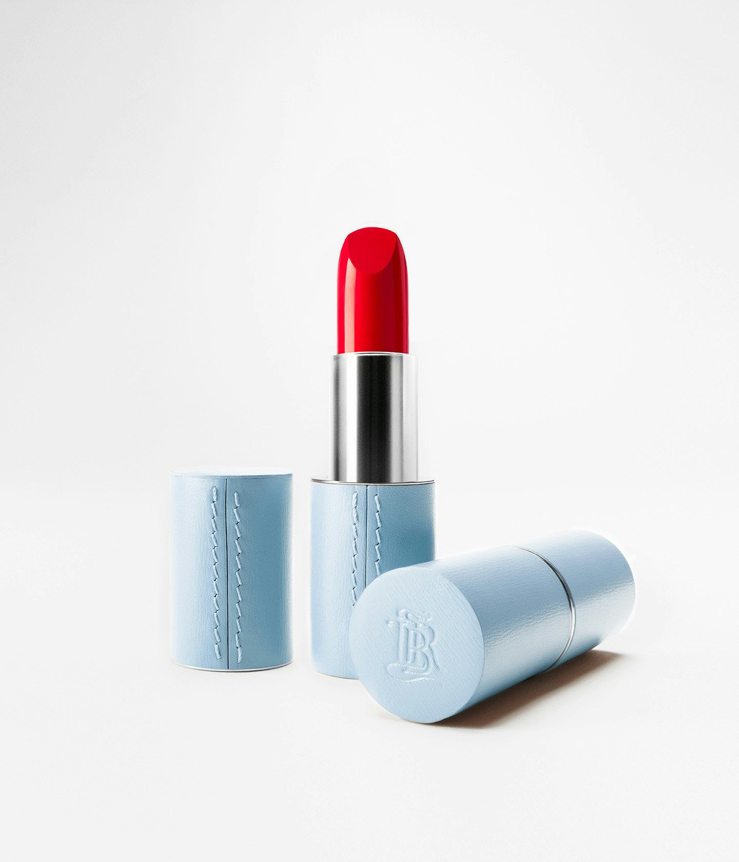 La bouche rouge upcycled fine leather case in Blue with La bouche rouge 21 Satin lipstick shade
