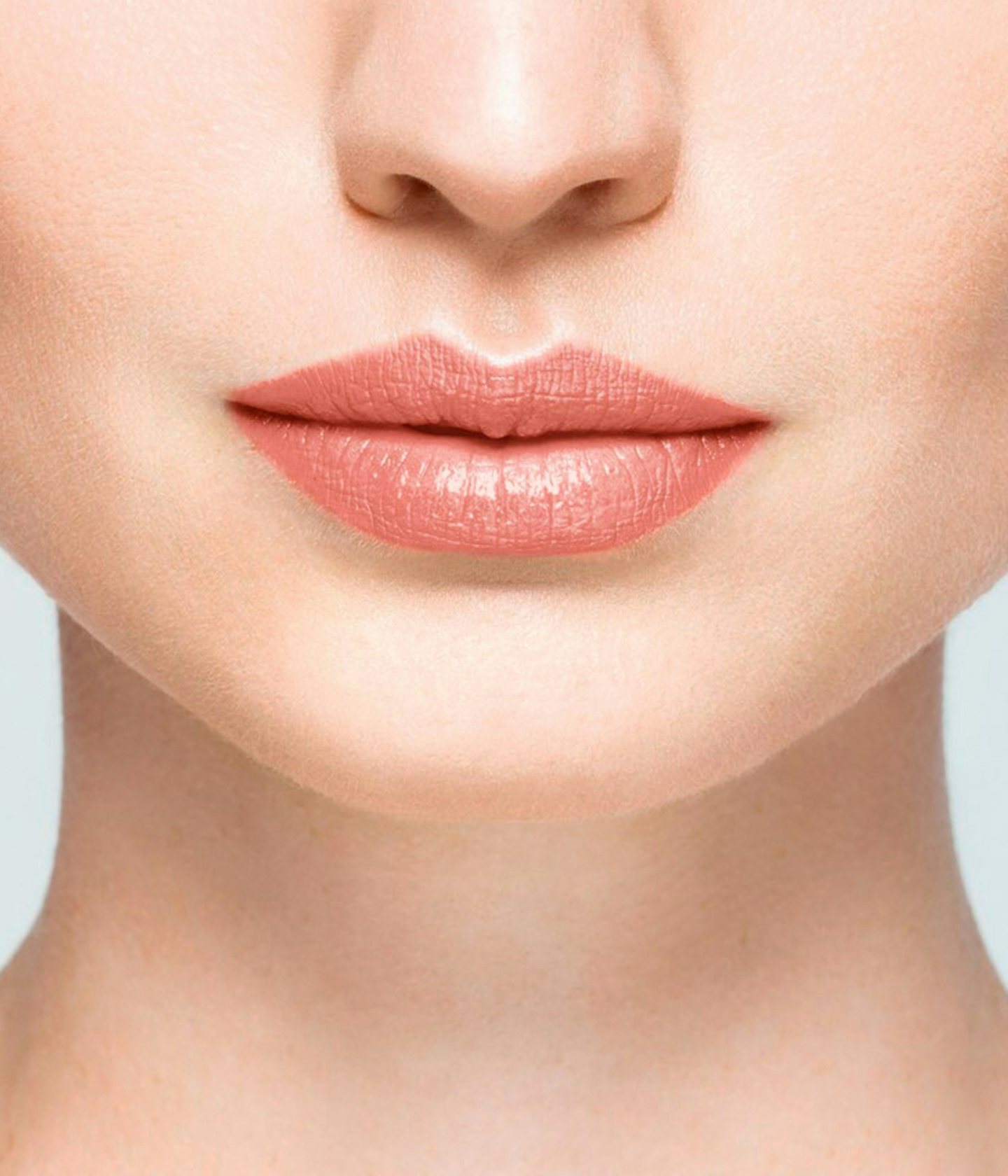 La bouche rouge Peach balm lipstick shade on the lips of a fair skin model