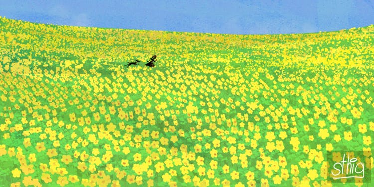 A girl and dog running in a field of flowers