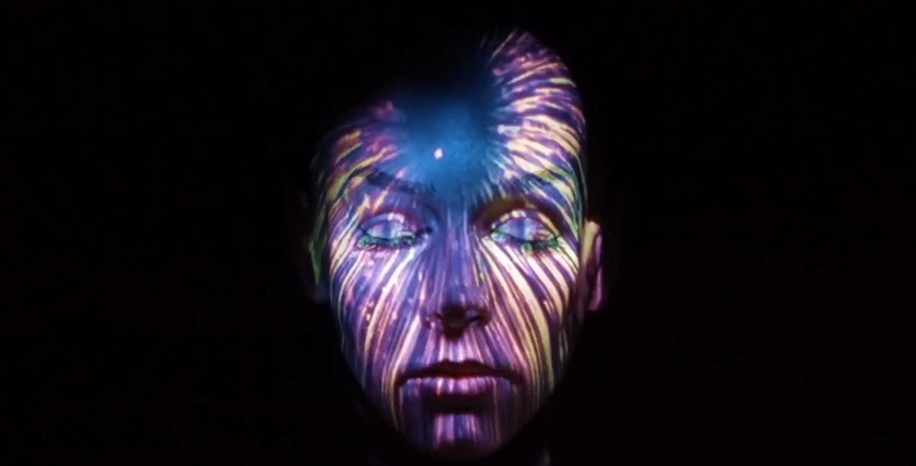 A woman with art projected on to her face