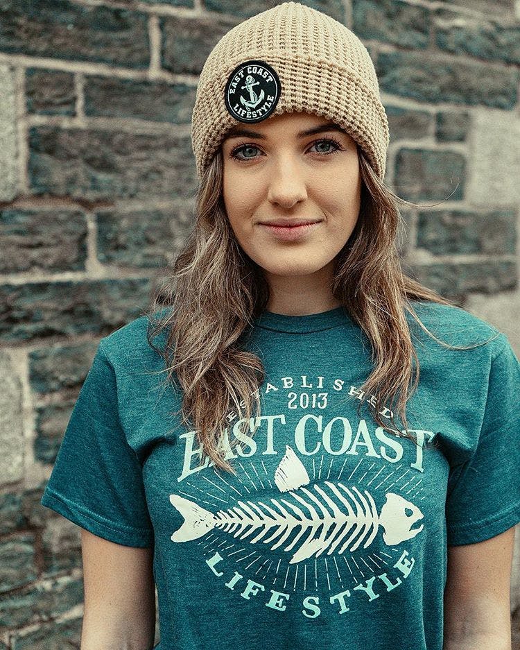 A woman in an East Coast t-shirt