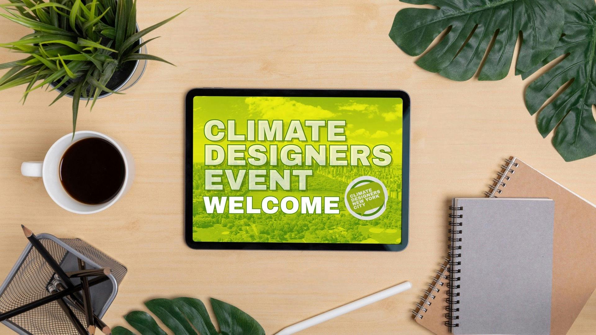 A desktop showing plants and a cup of coffee and an ipad with Climate Designers Event welcome screen