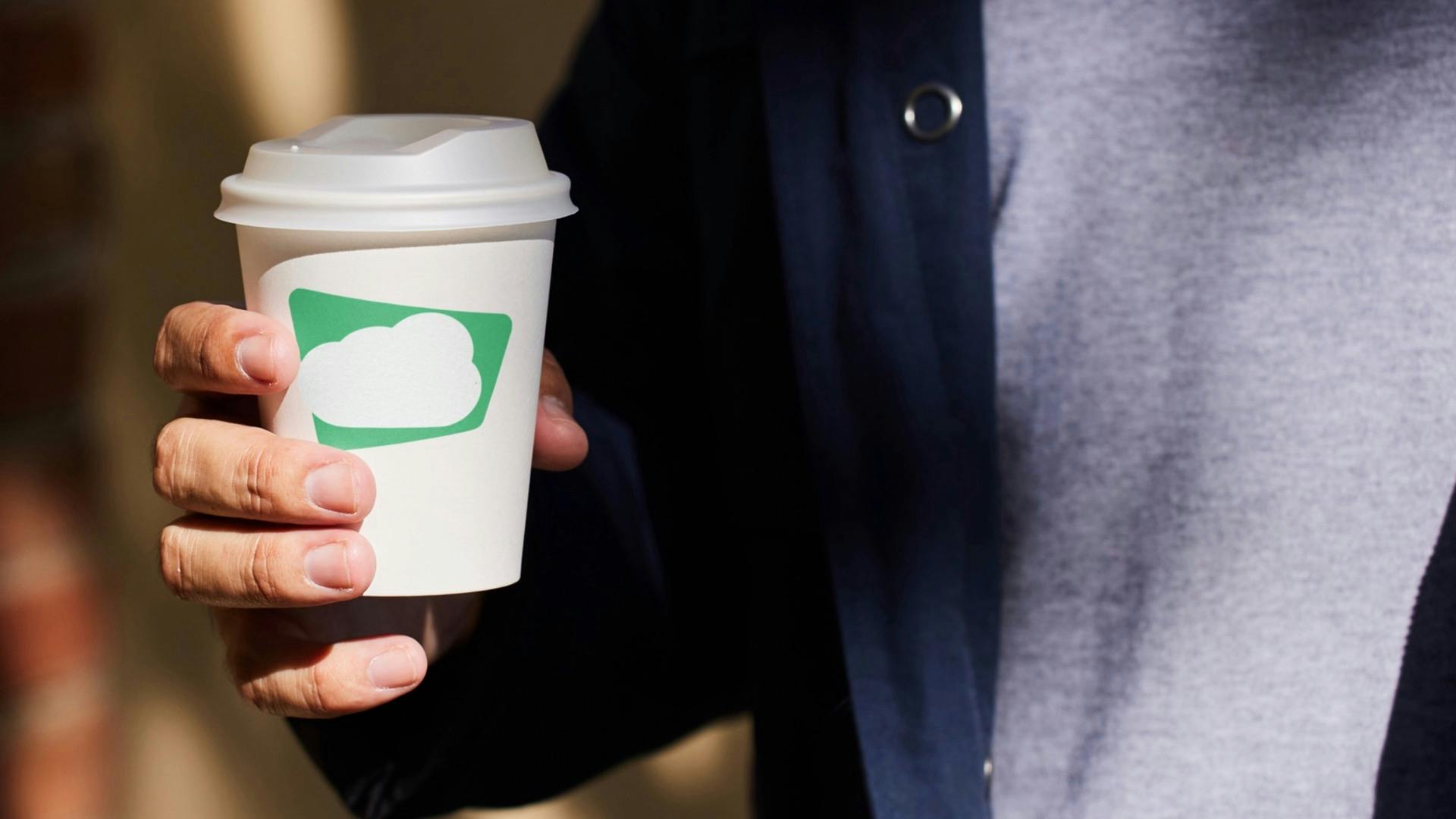 Green Sky logo on a coffee cup