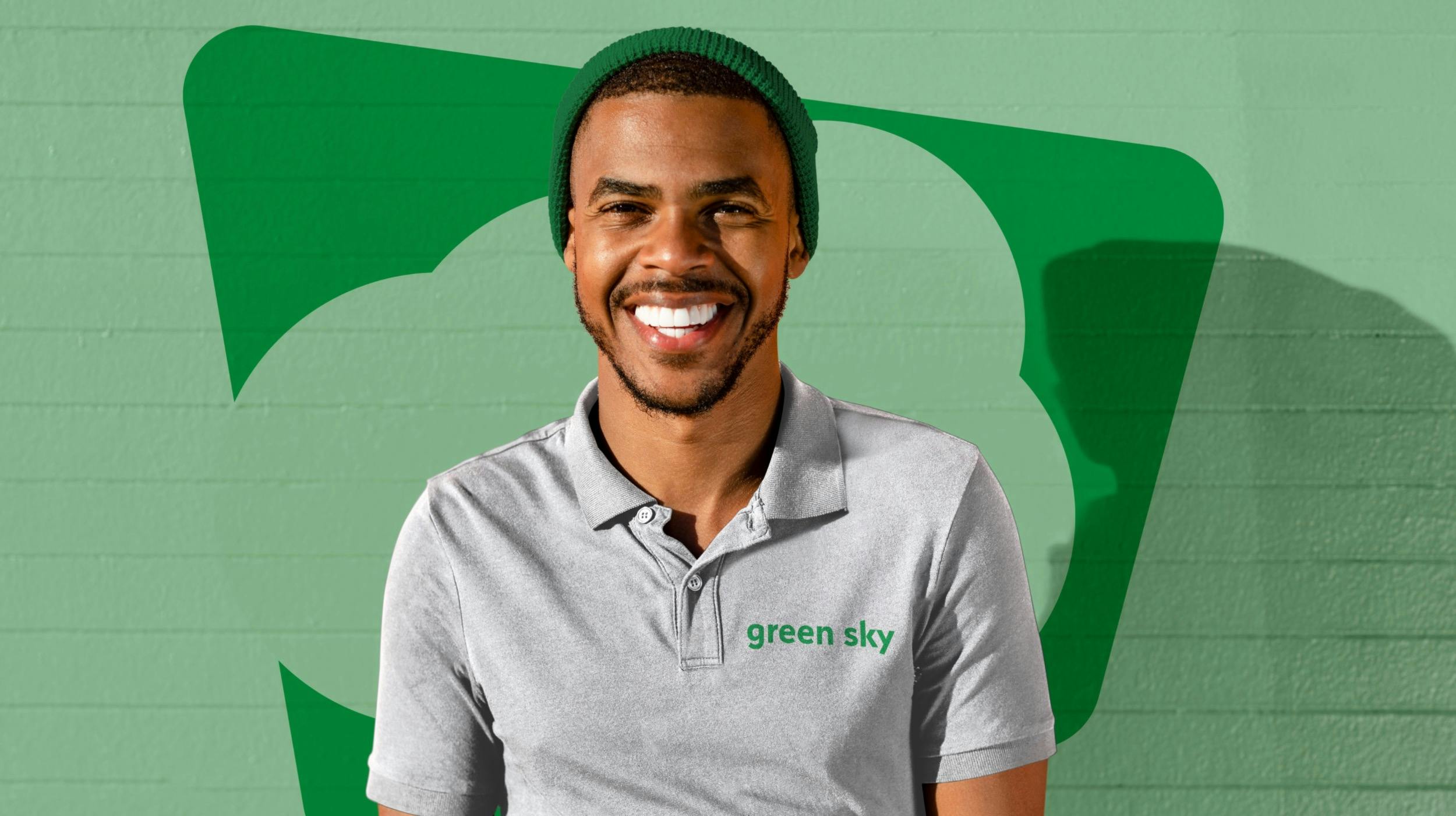 Man standing in front of Green Sky logo
