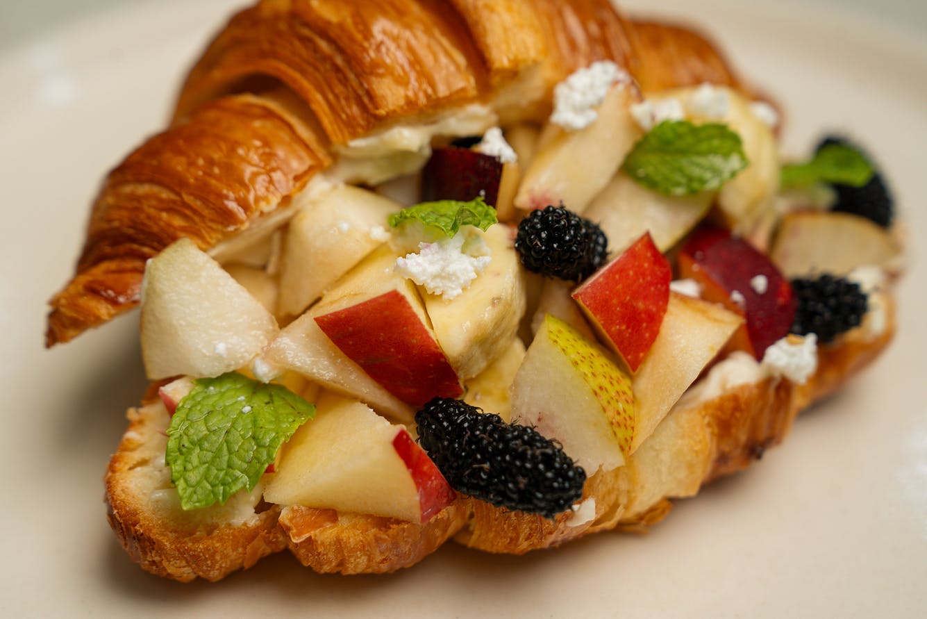 Photograph of croissant filled with fruit salad