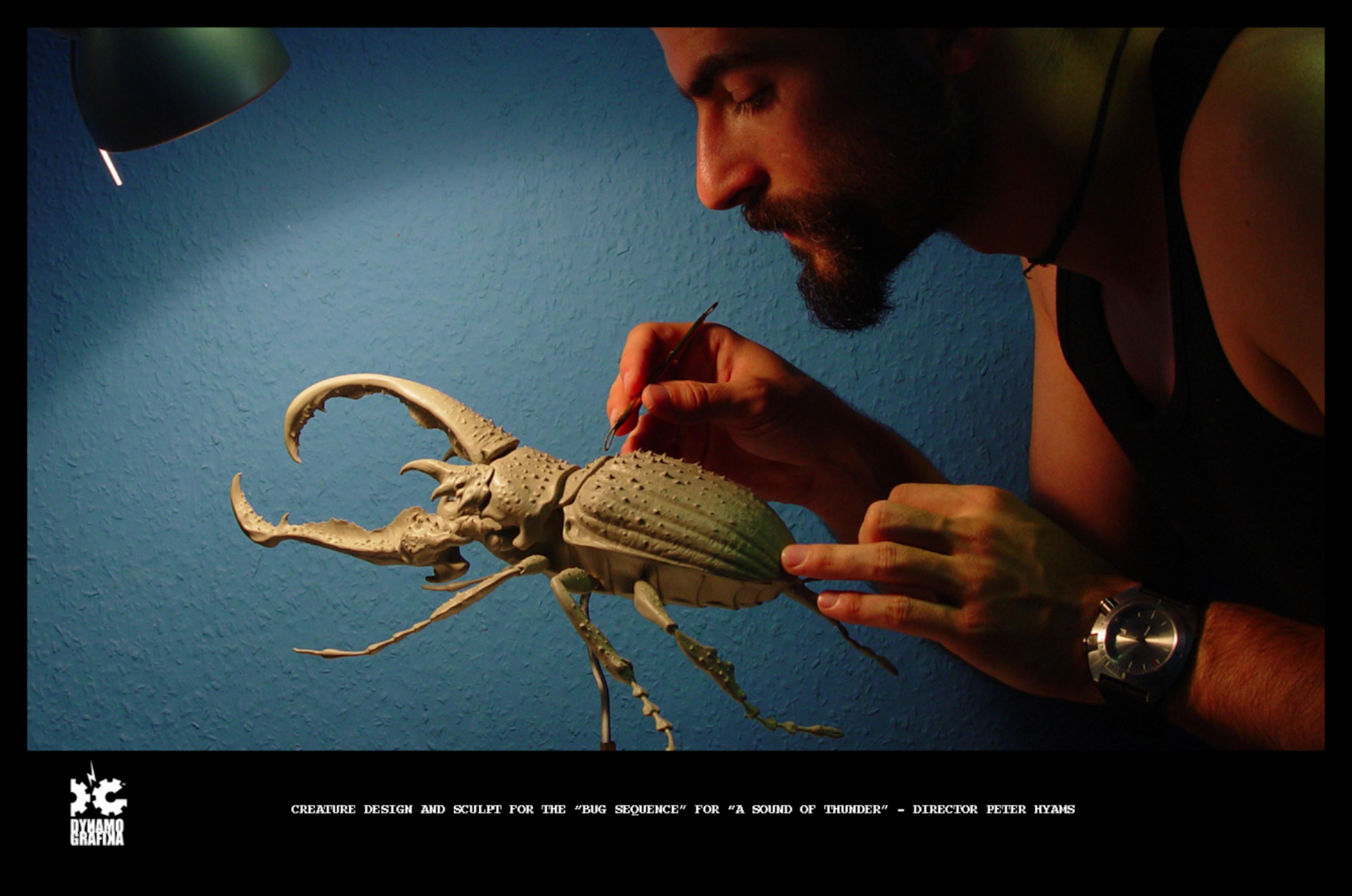 Photograph of a man making a model of a bug