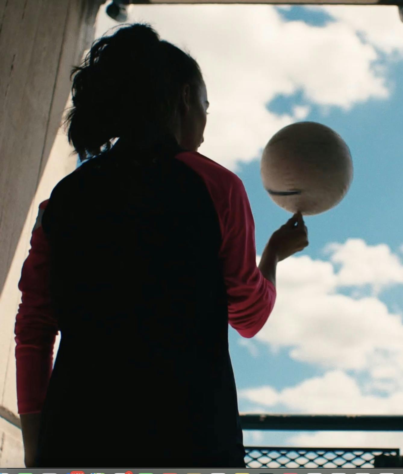 Photograph of a woman spinning a ball on her finger