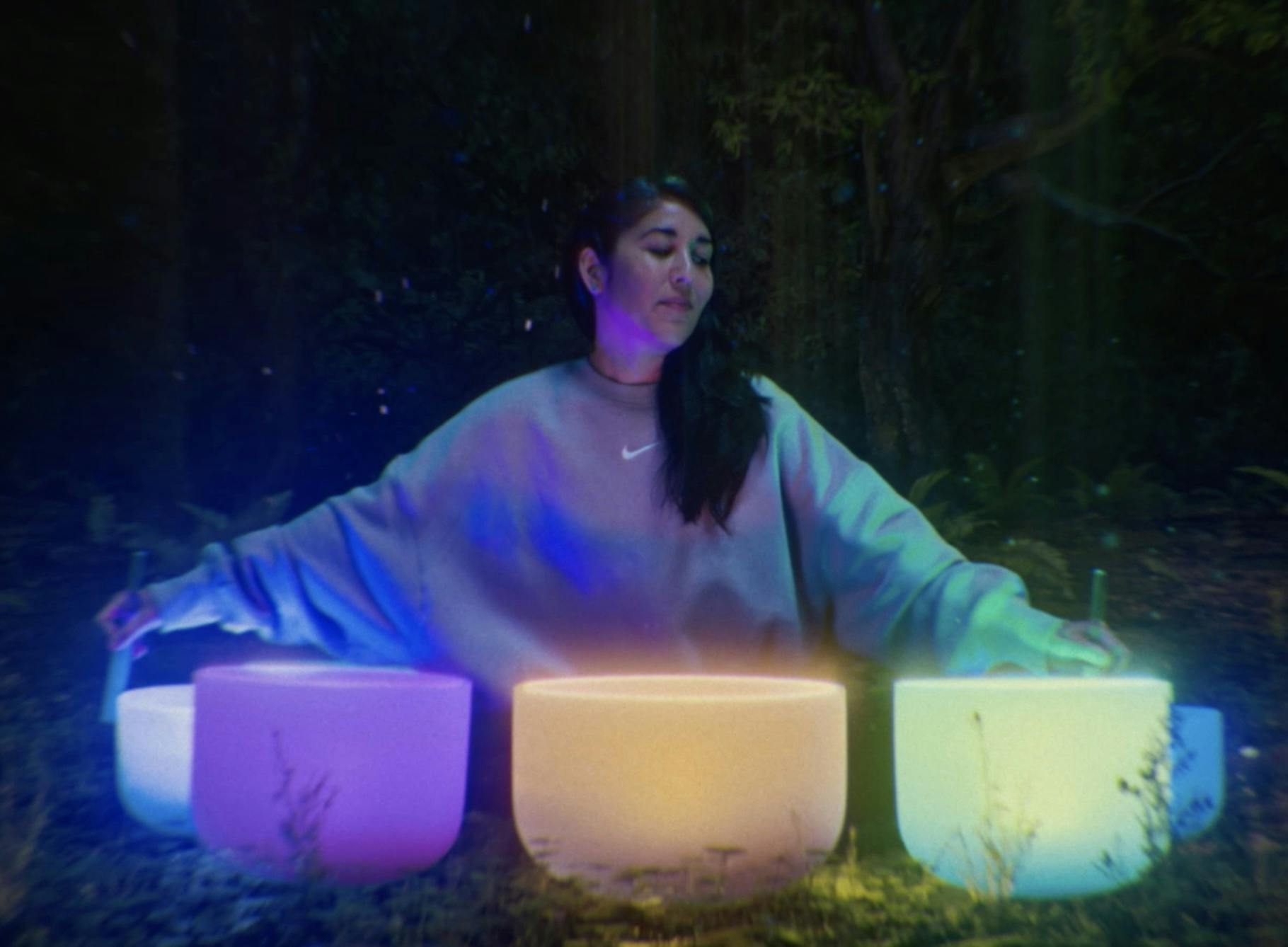Woman sitting in front of glowing pots