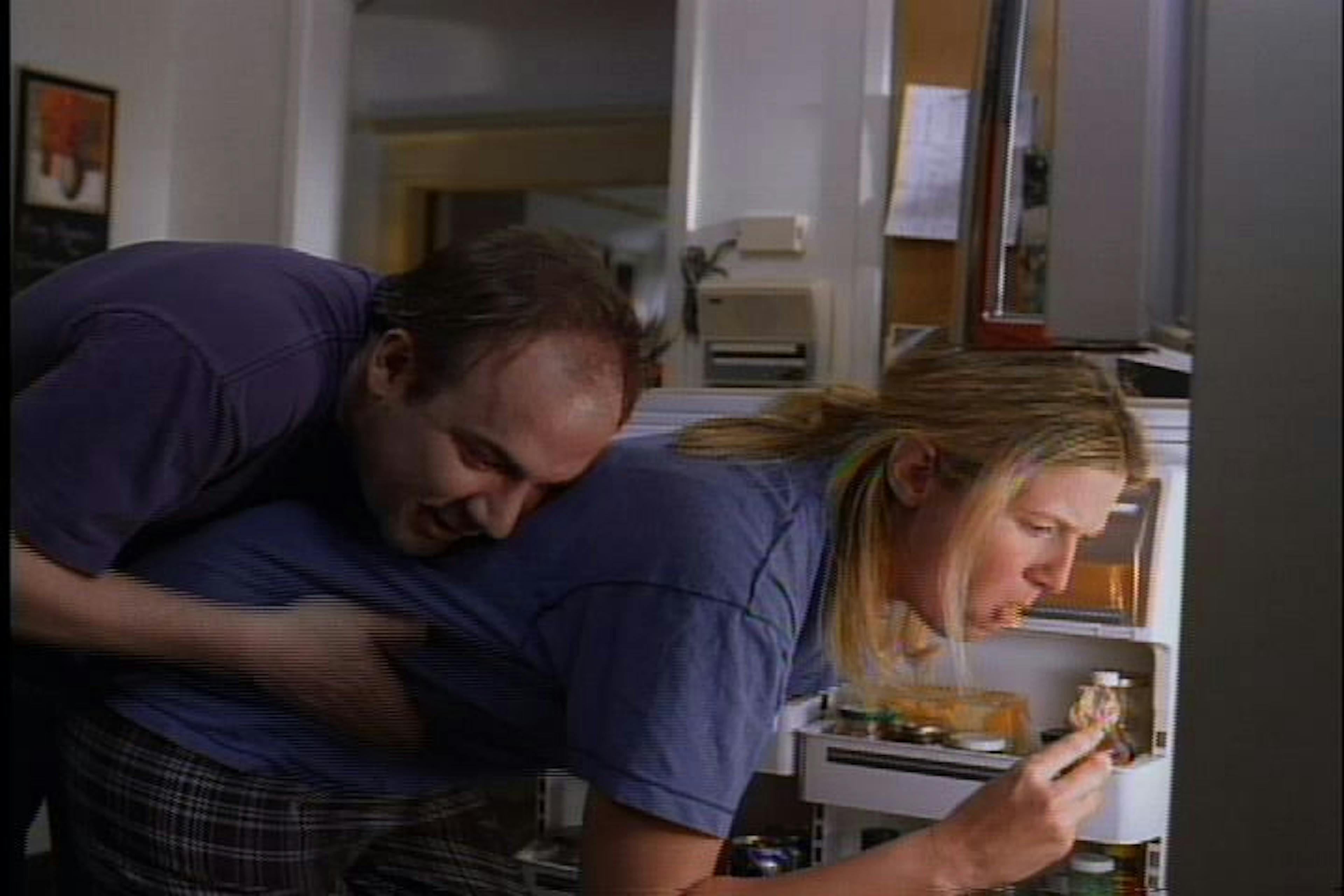 Woman eating from fridge