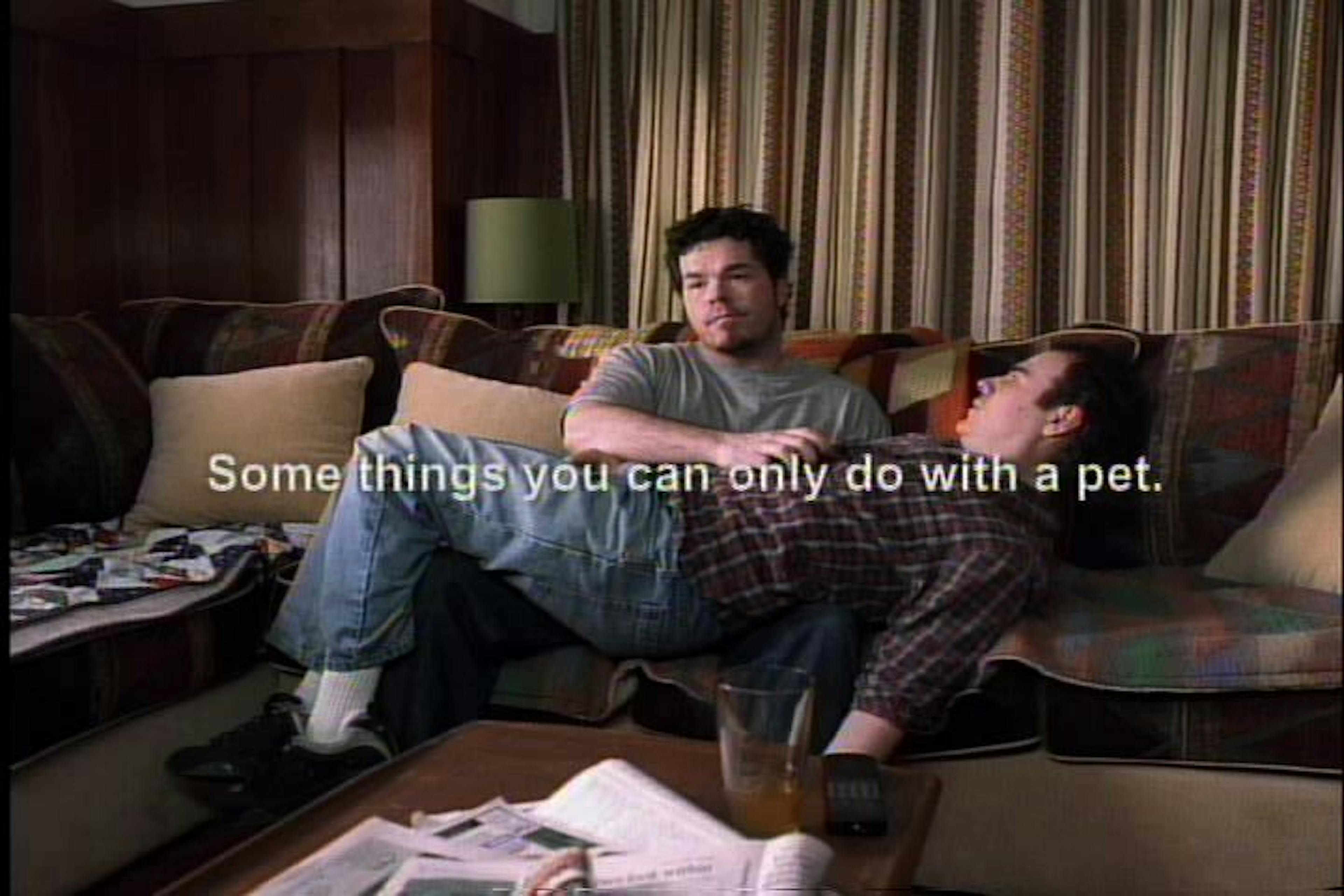 Man holding man on couch