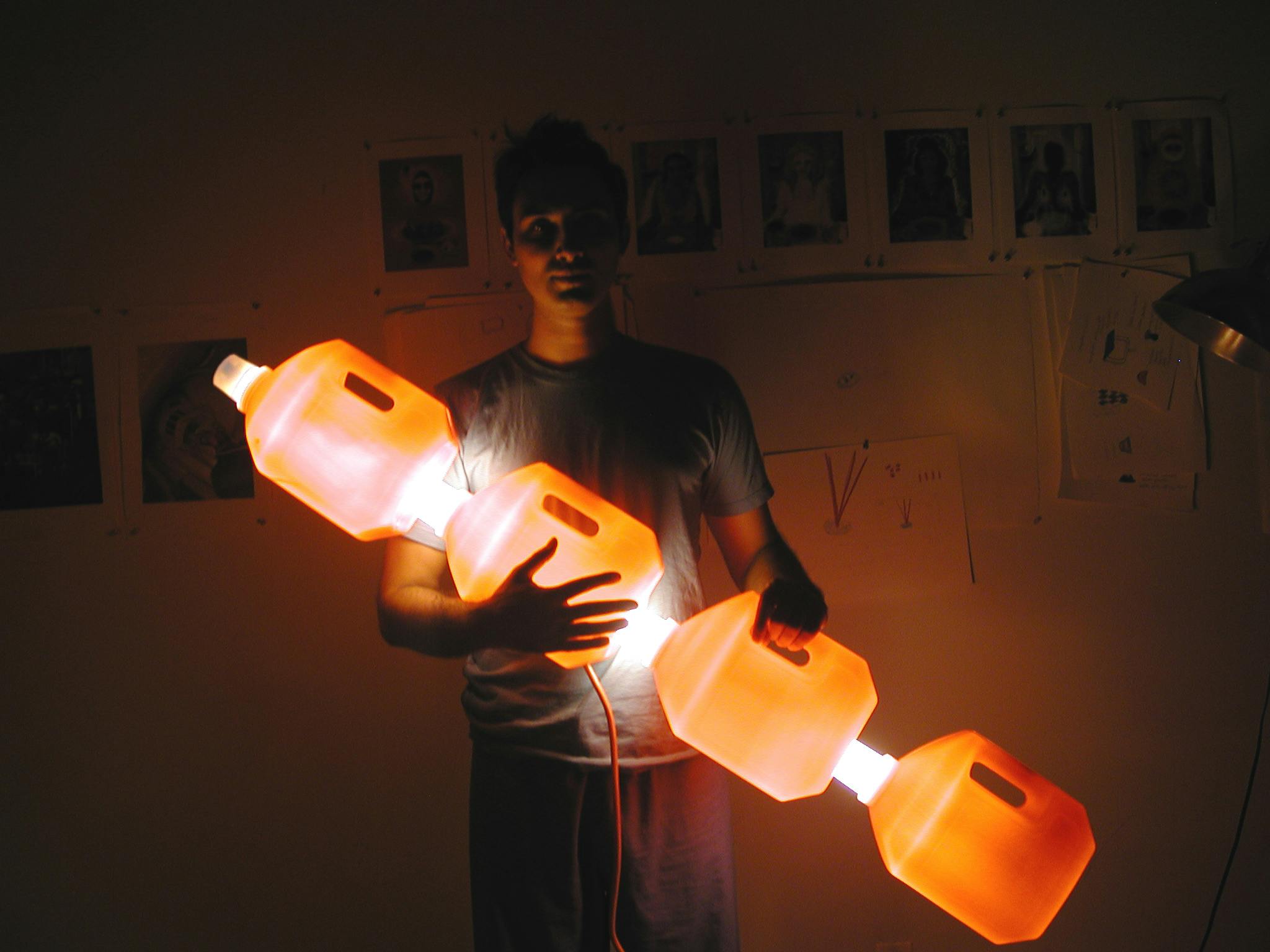 Man holding illuminated plastic jugs