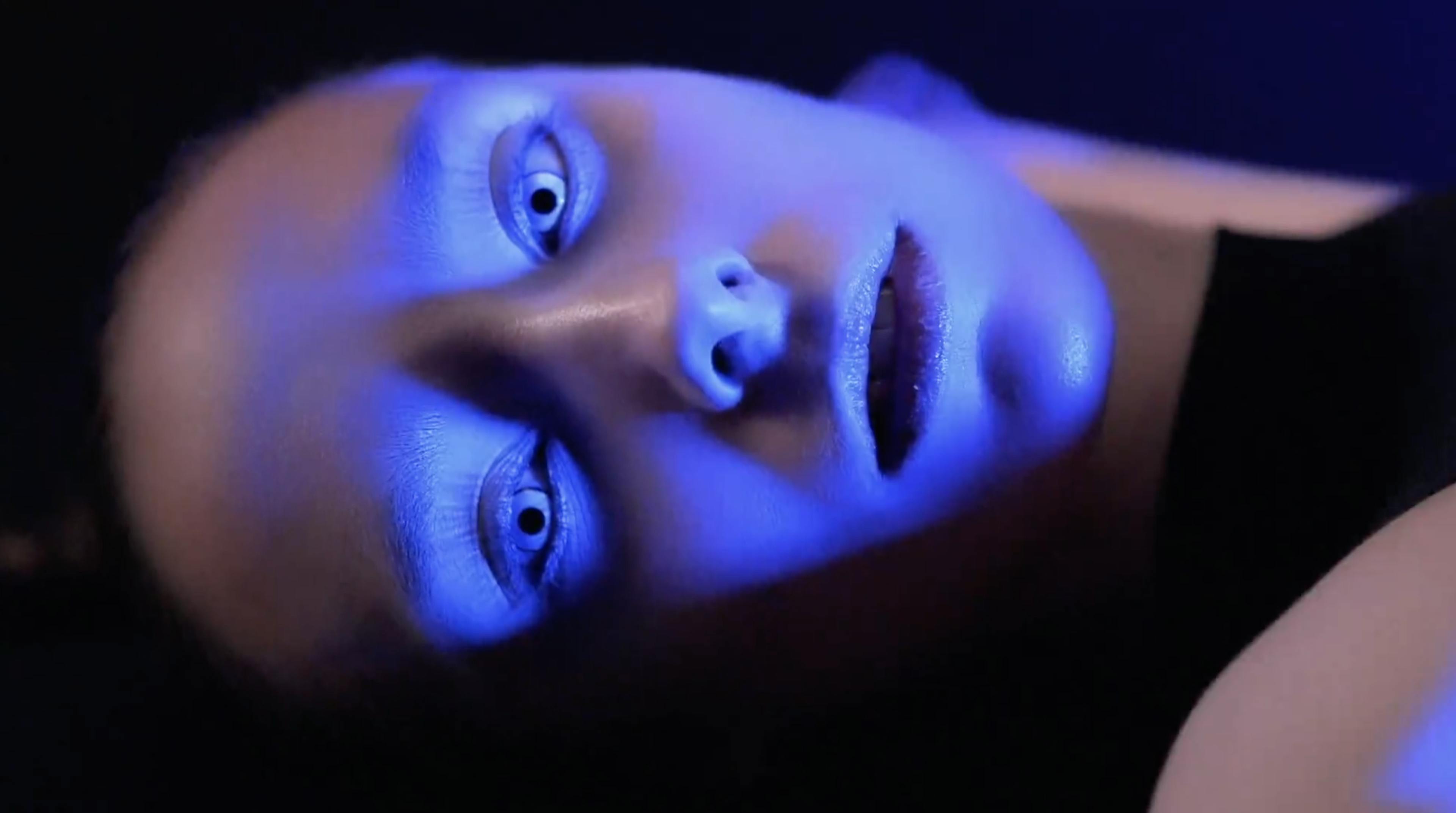Photograph of a blue lit woman