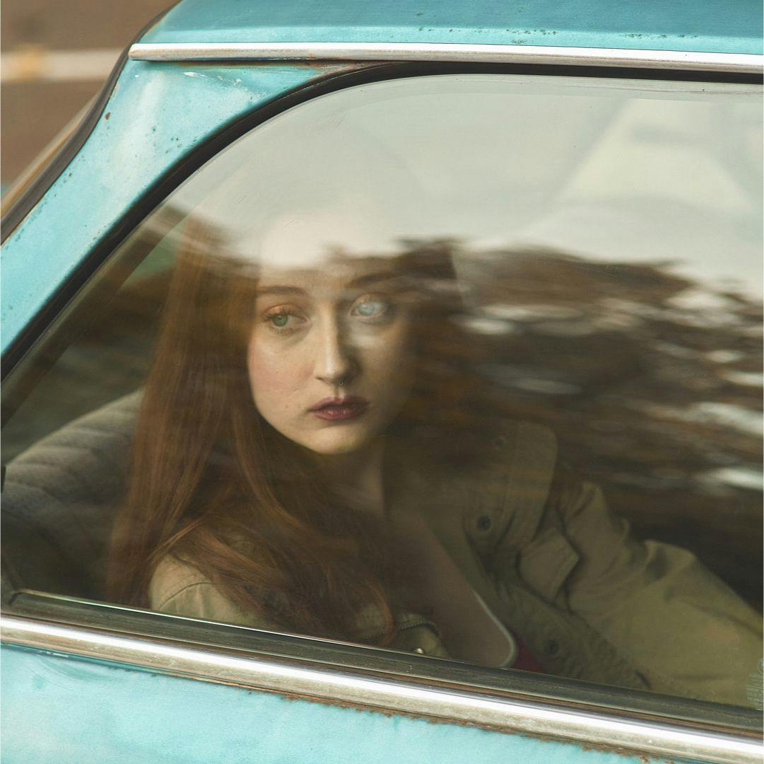 A woman looking out a car window