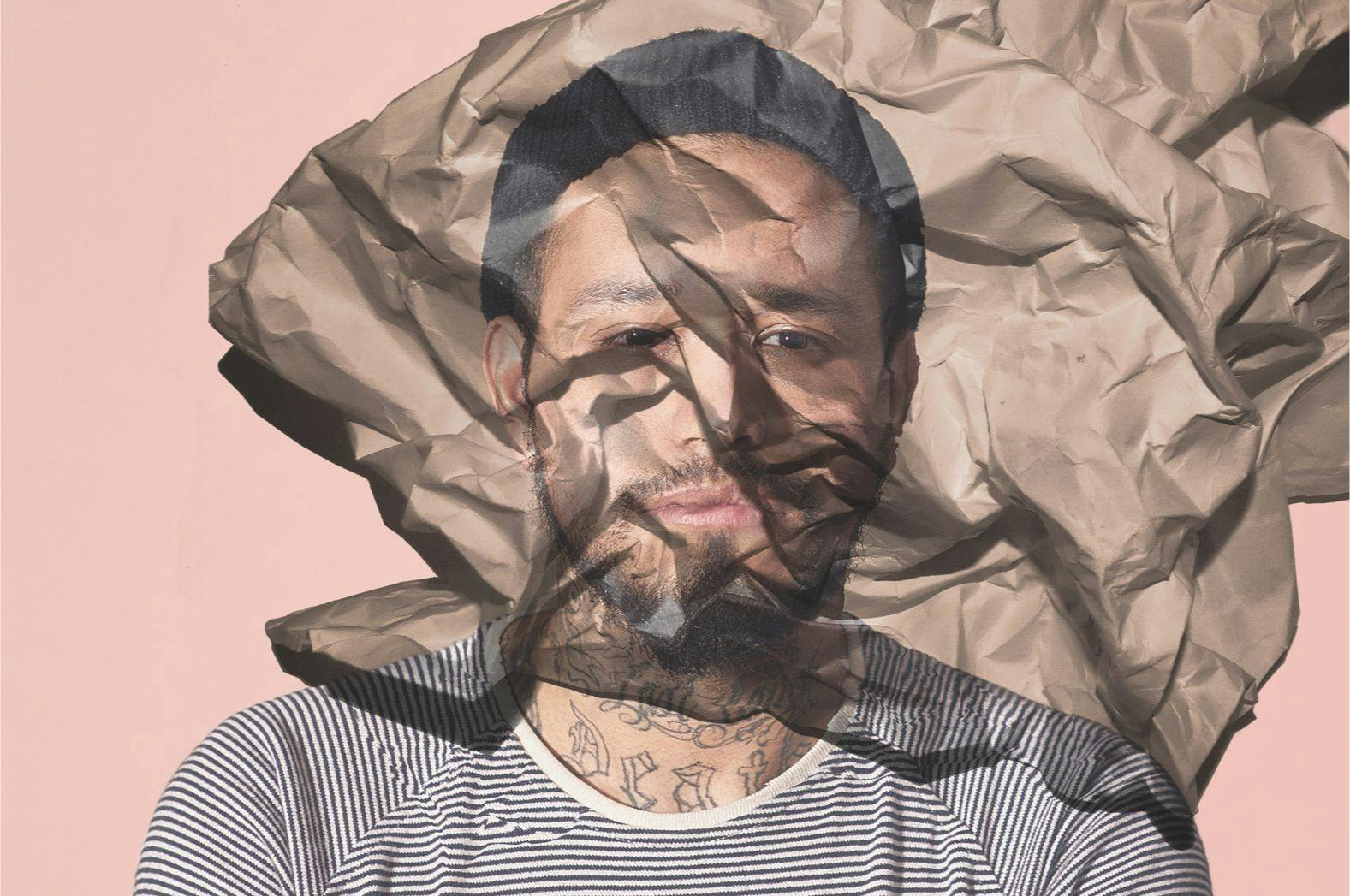 Male portrait projected onto wrinkled paper