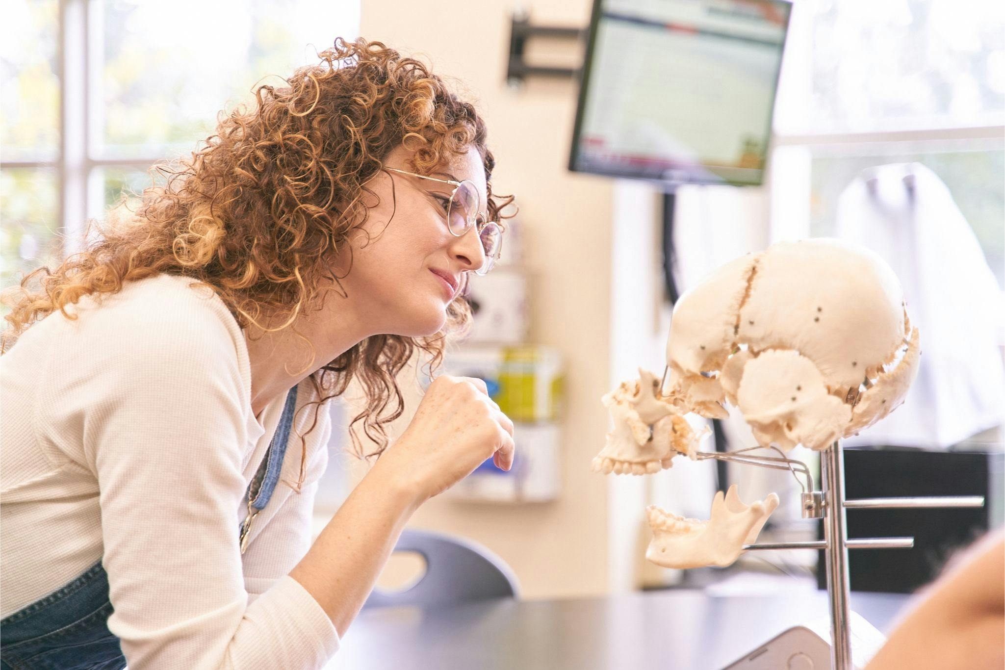 Woman inspecting skull