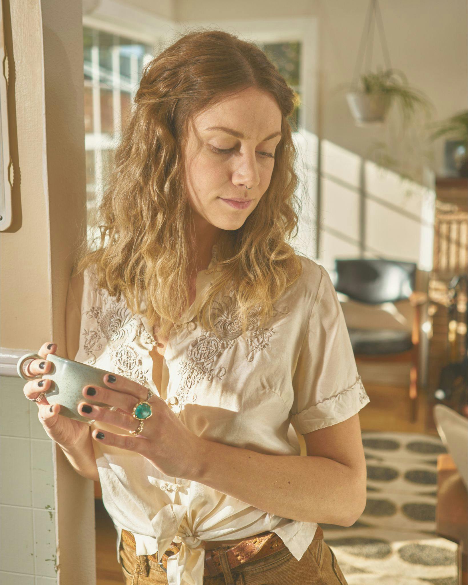 Woman leaning on door frame