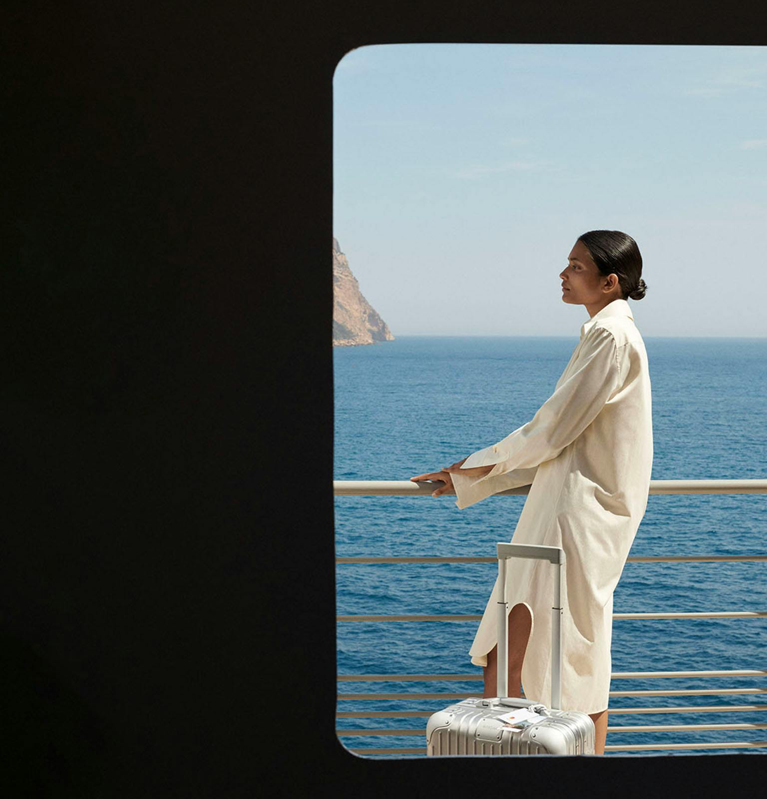 Rimowa ad with woman standing on ship