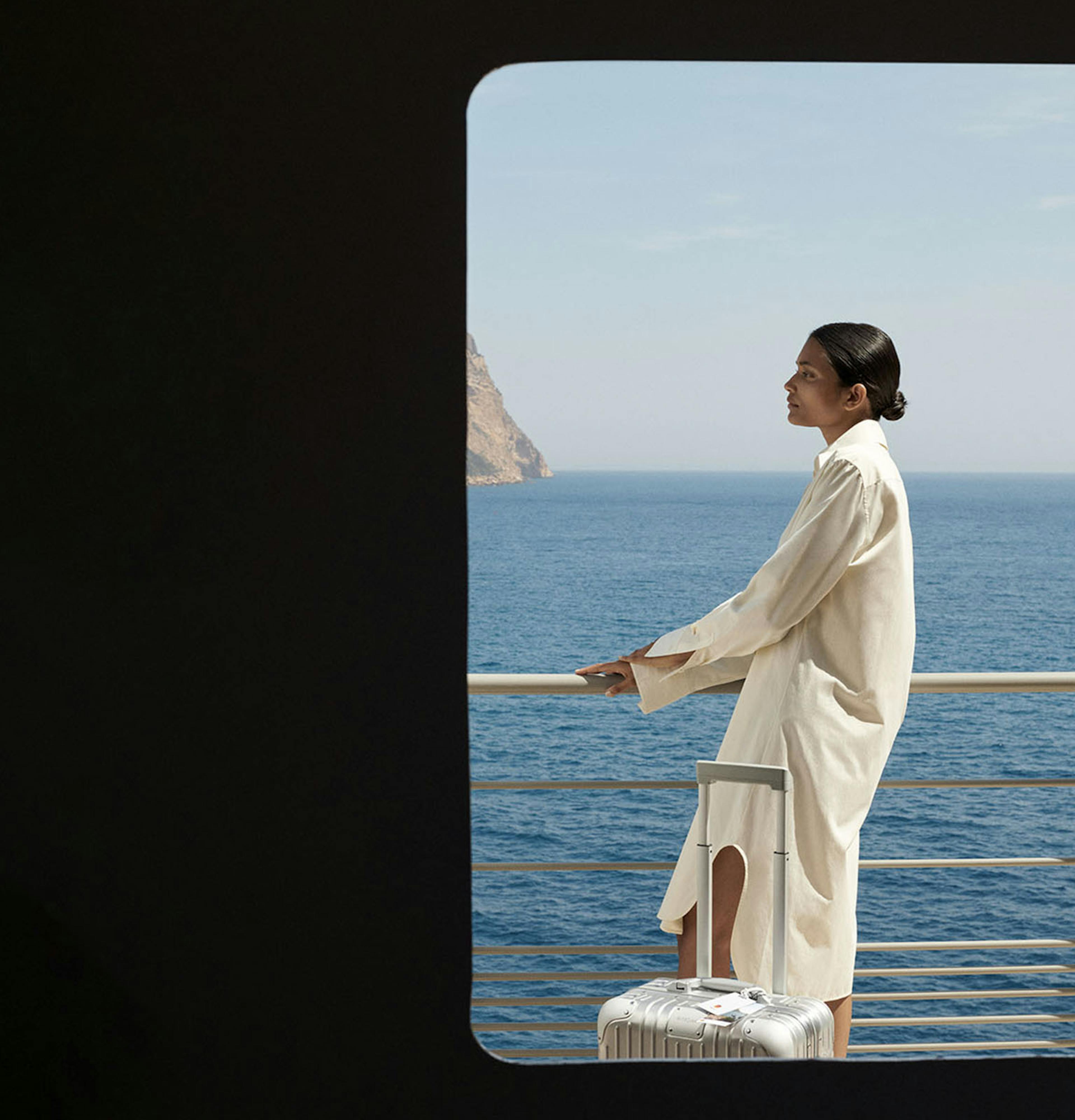 Rimowa ad with woman standing on ship