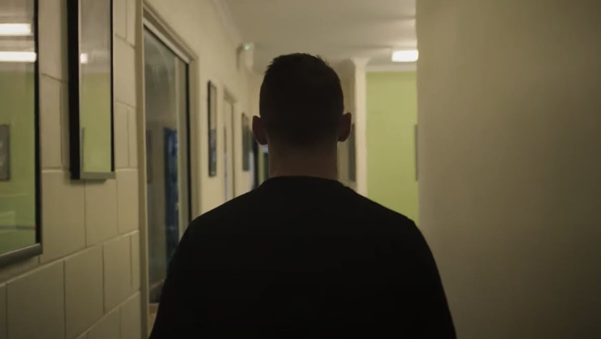 A man walking down a hallway