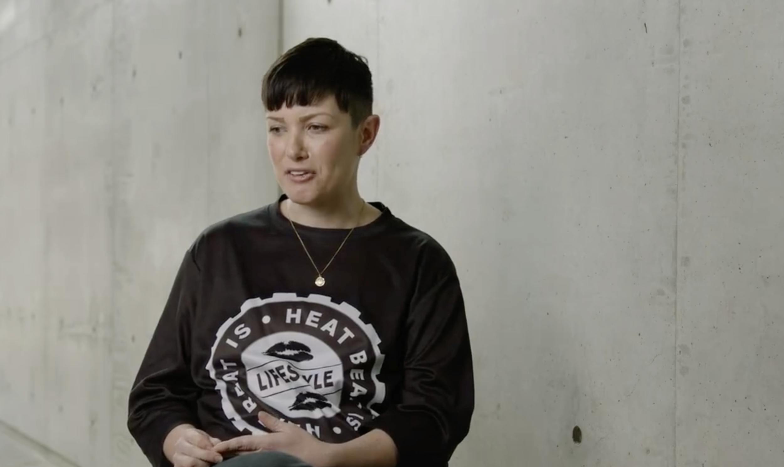 woman talking near concrete wall
