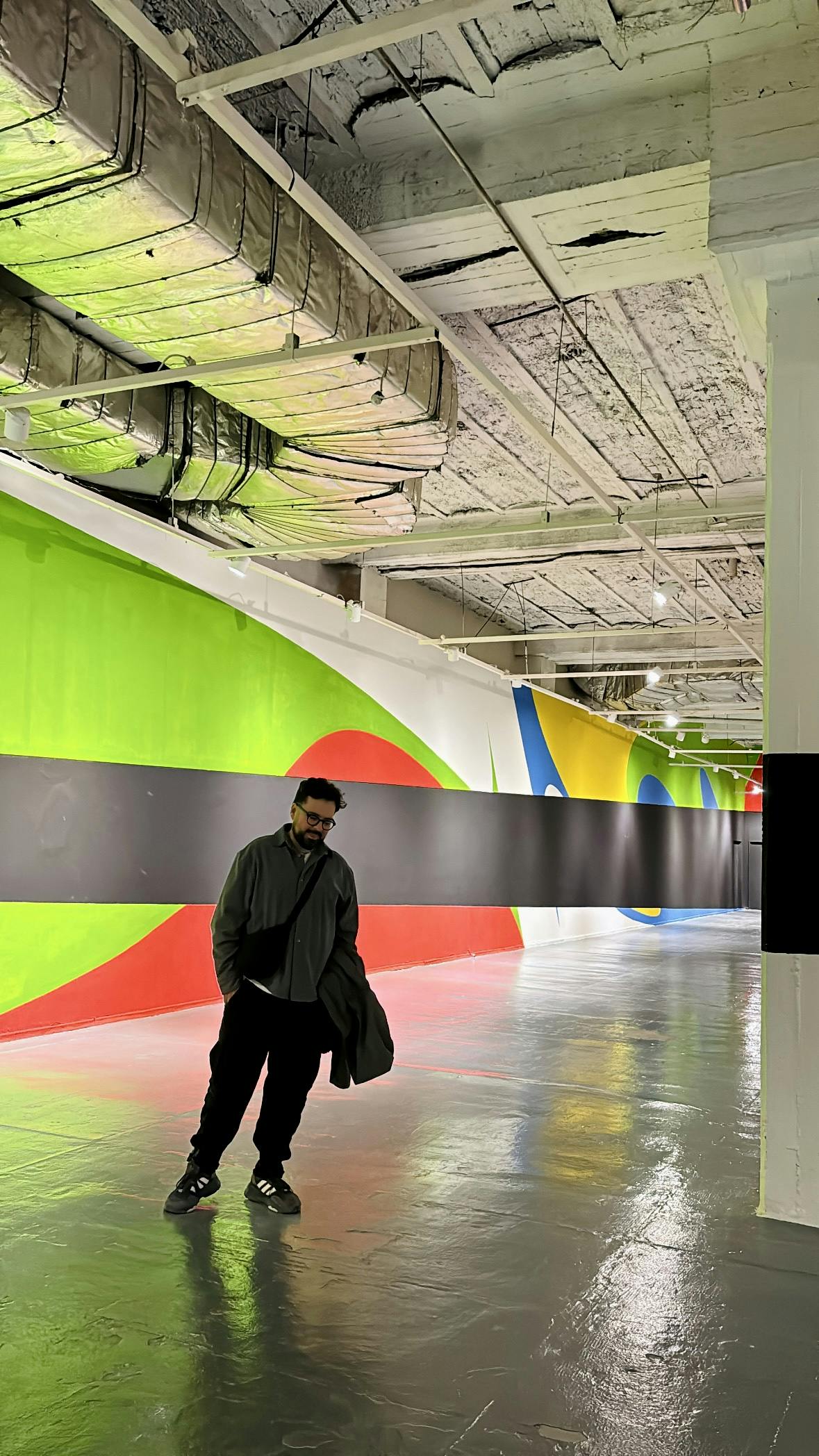 Man in hallway with mural