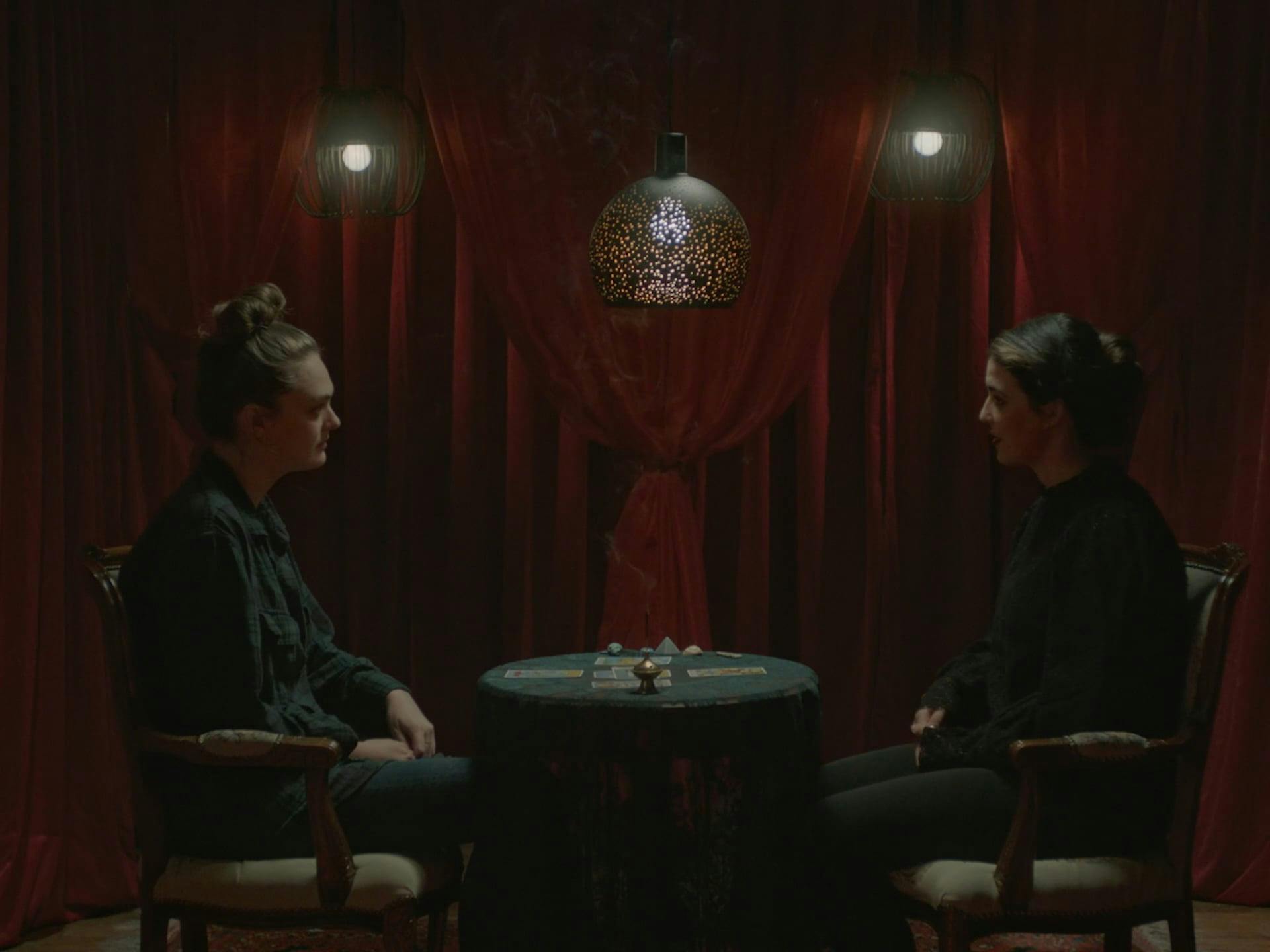 To women sitting at a dark table