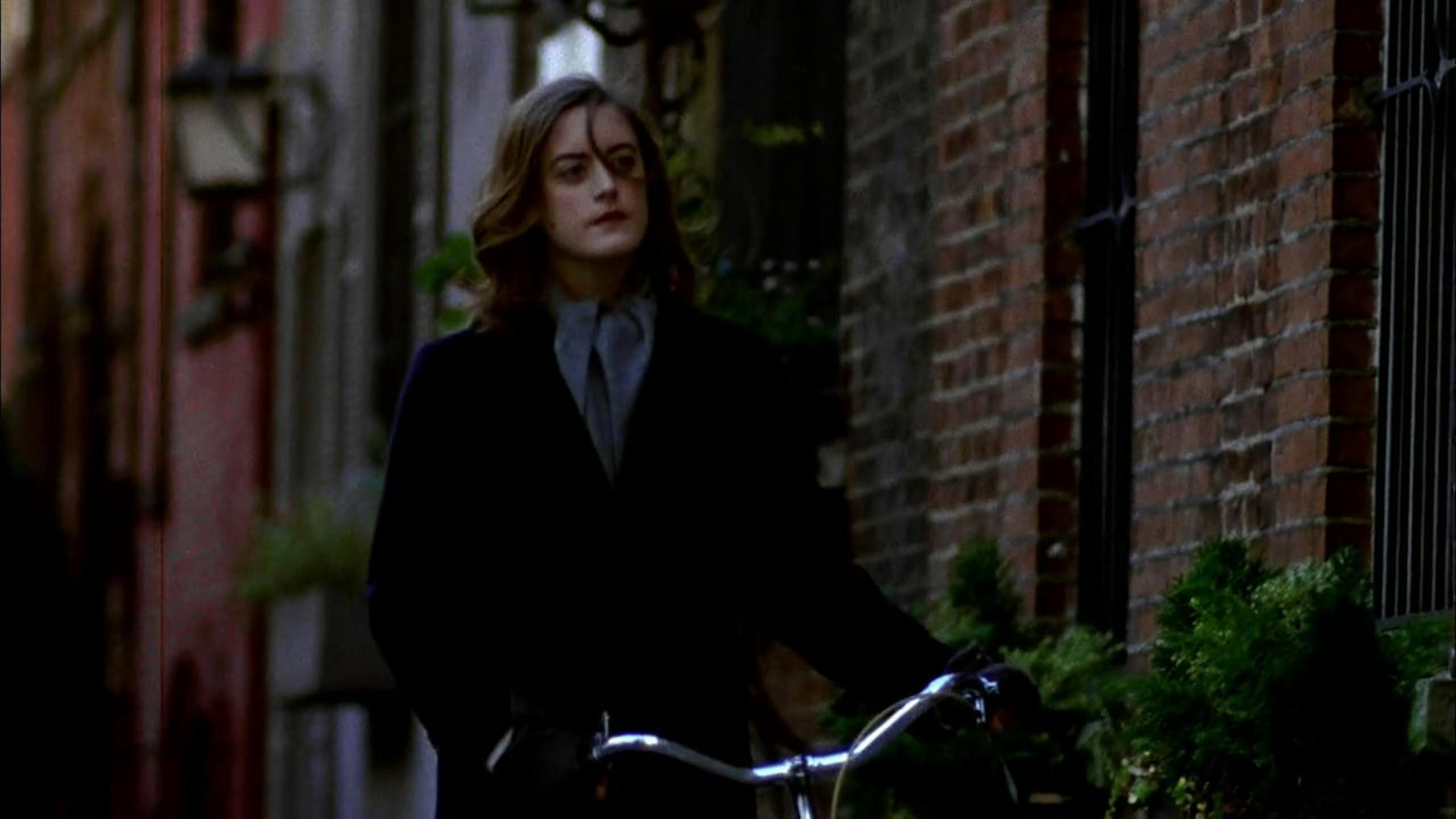 A woman walking her bike