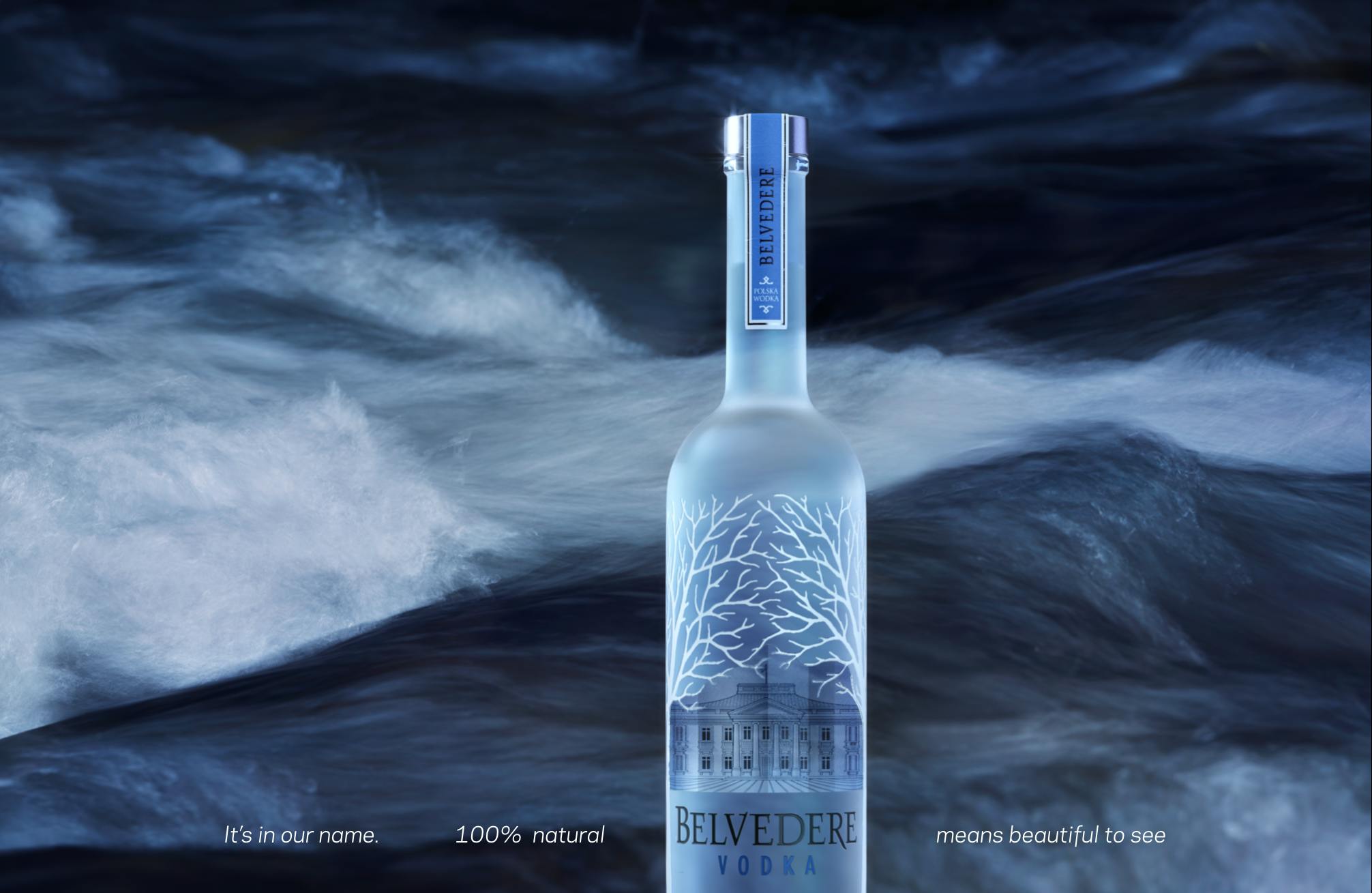 A Belvedere Vodka bottle in front of the moving ocean