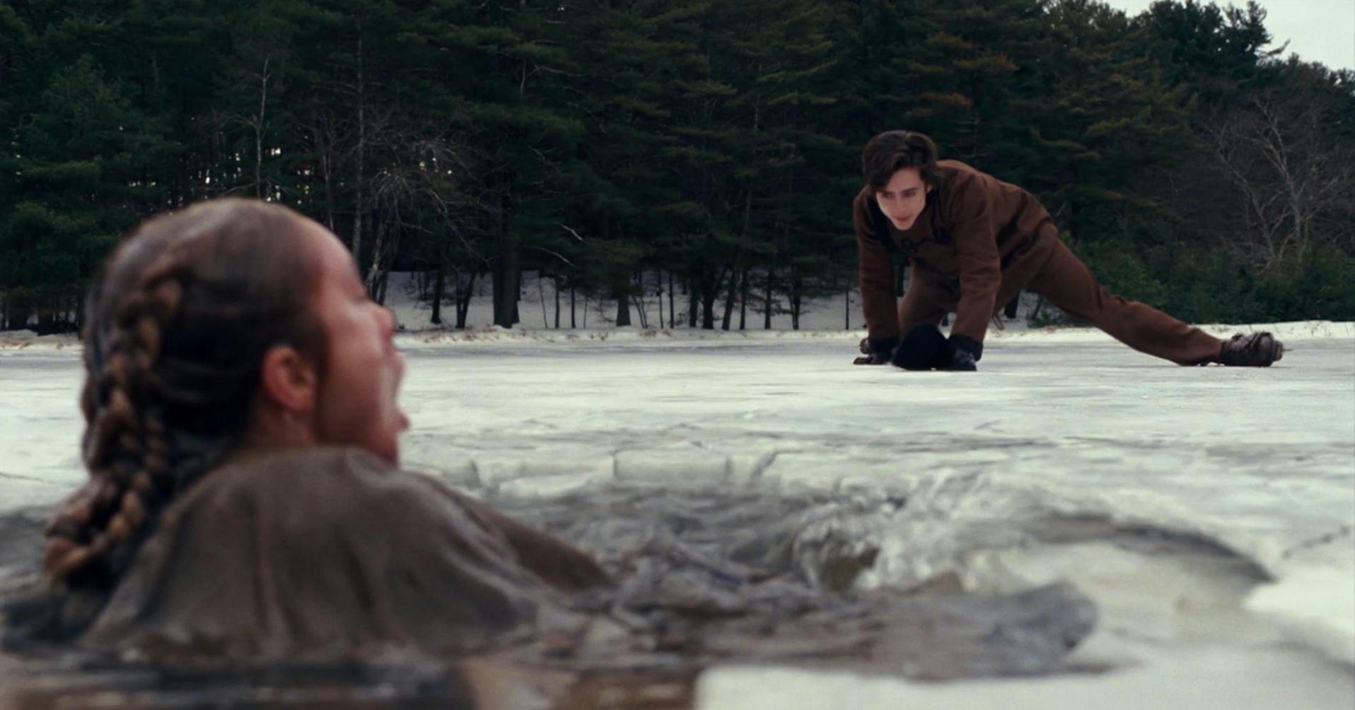 A man attempting to rescue a woman drowning in icy water