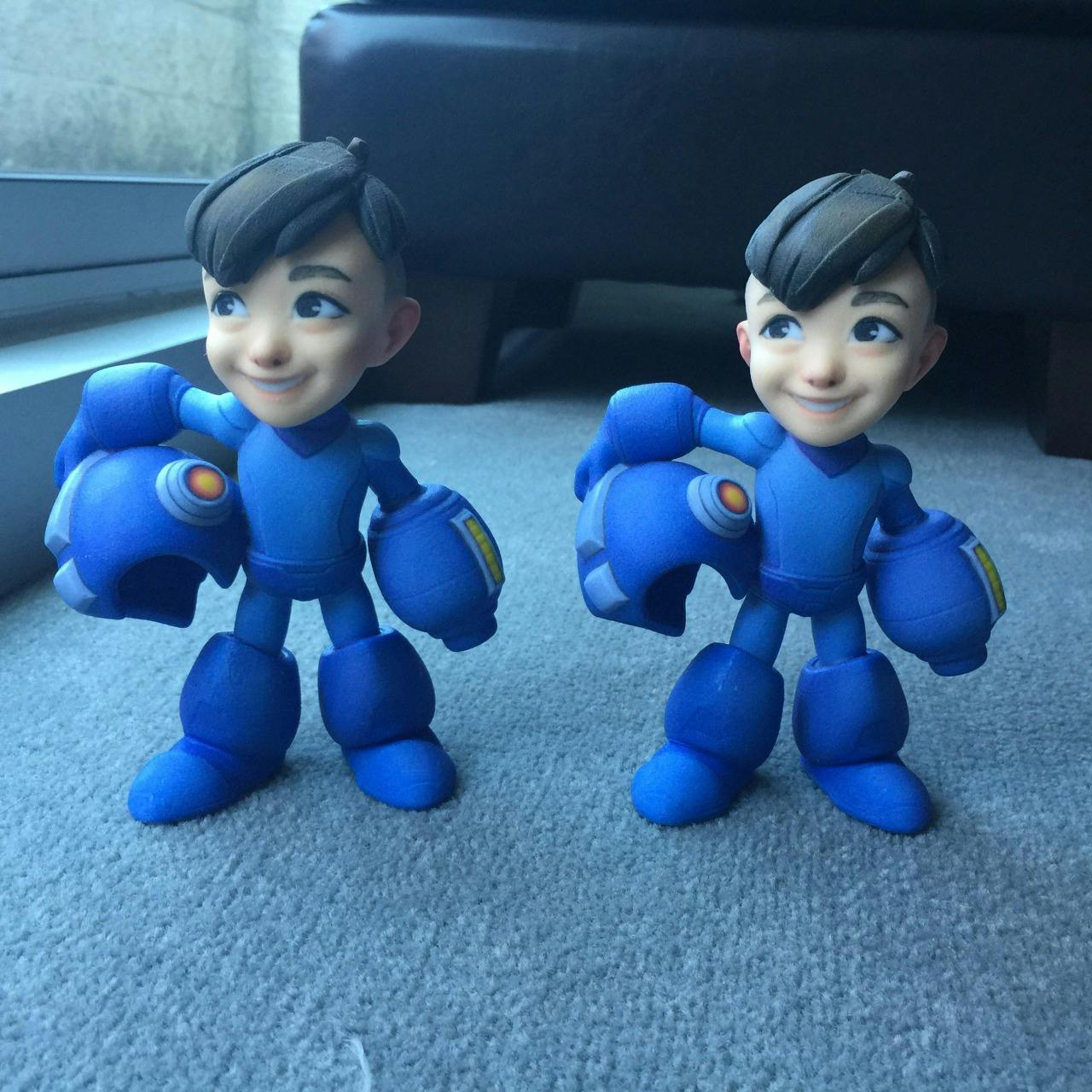 Two mega man statuettes standing beside each other