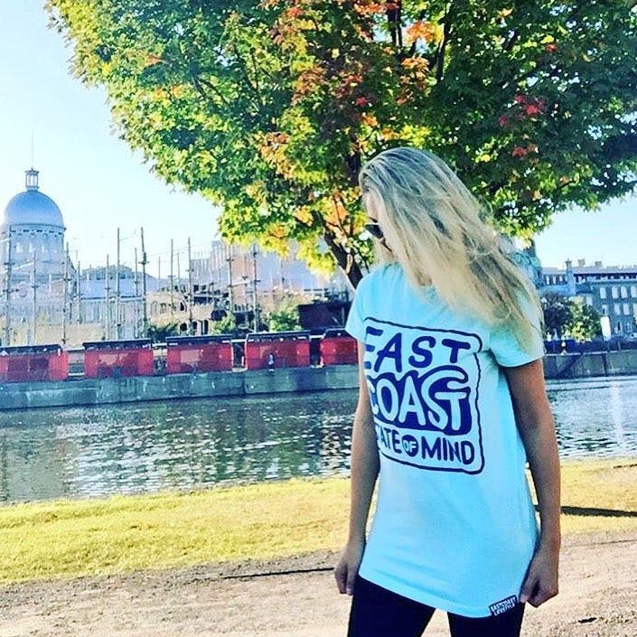 A woman wearing an East Coast t-shirt