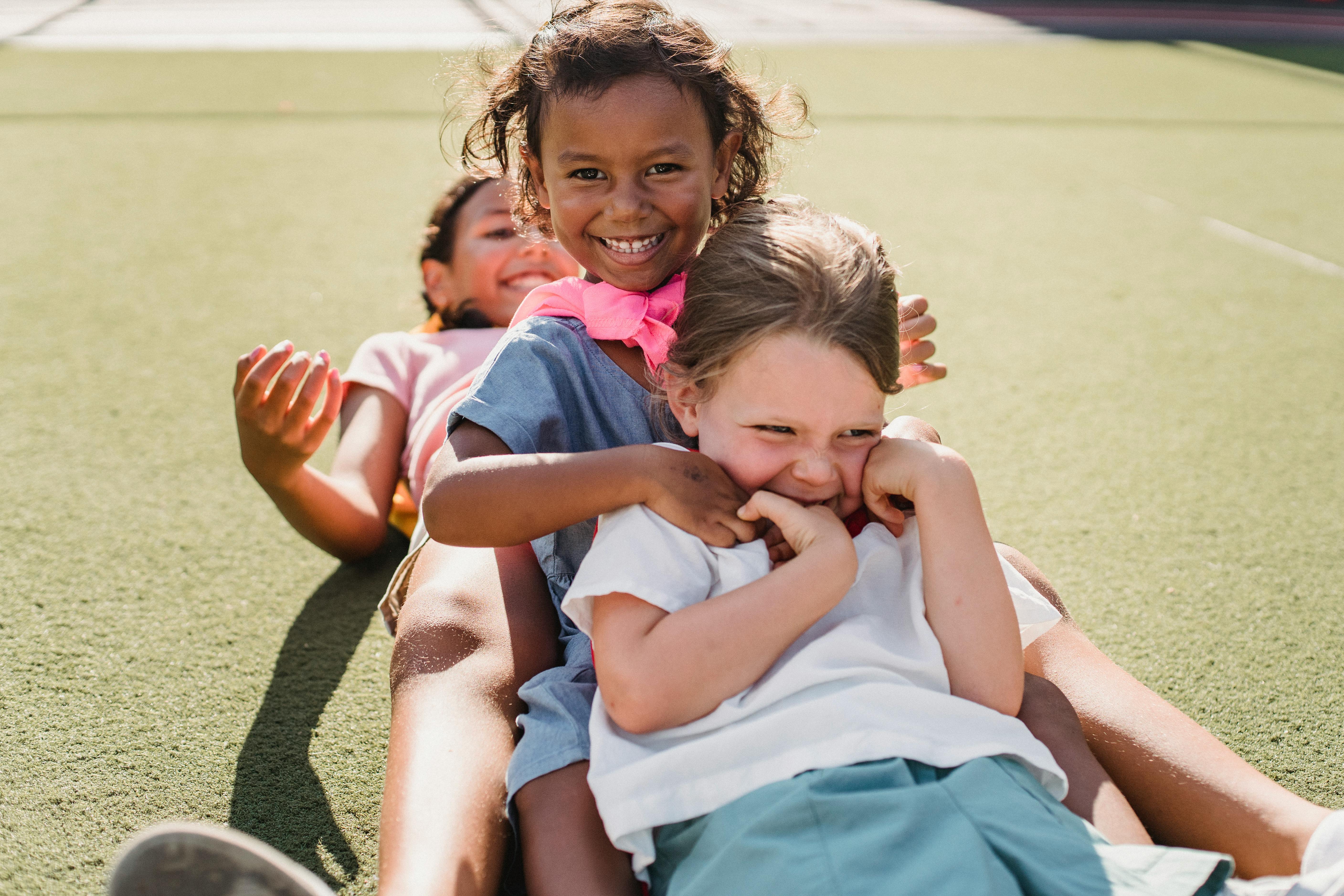 Three girls playing outdoors in the sun
