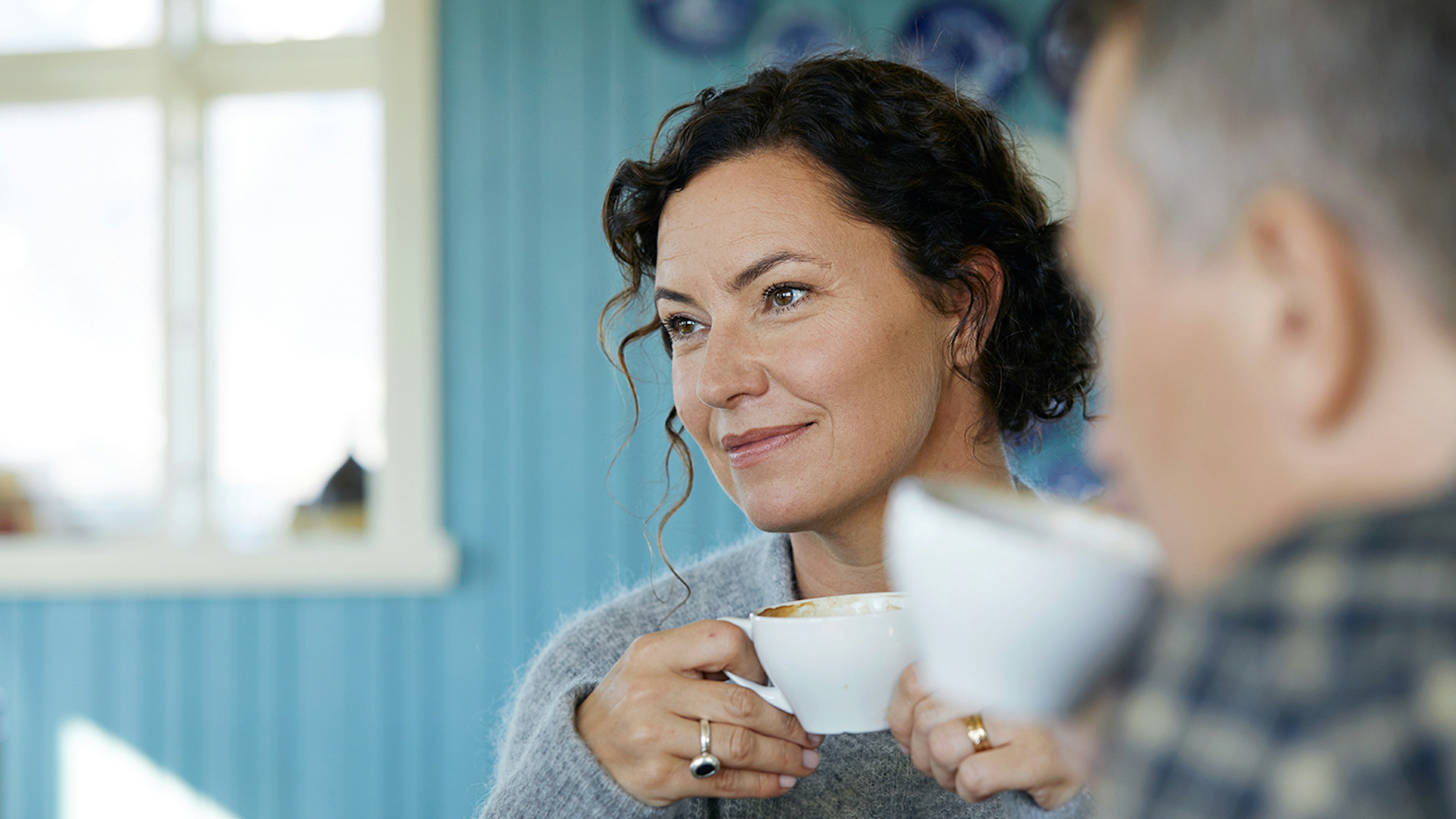 Kona og maður með kaffibolla