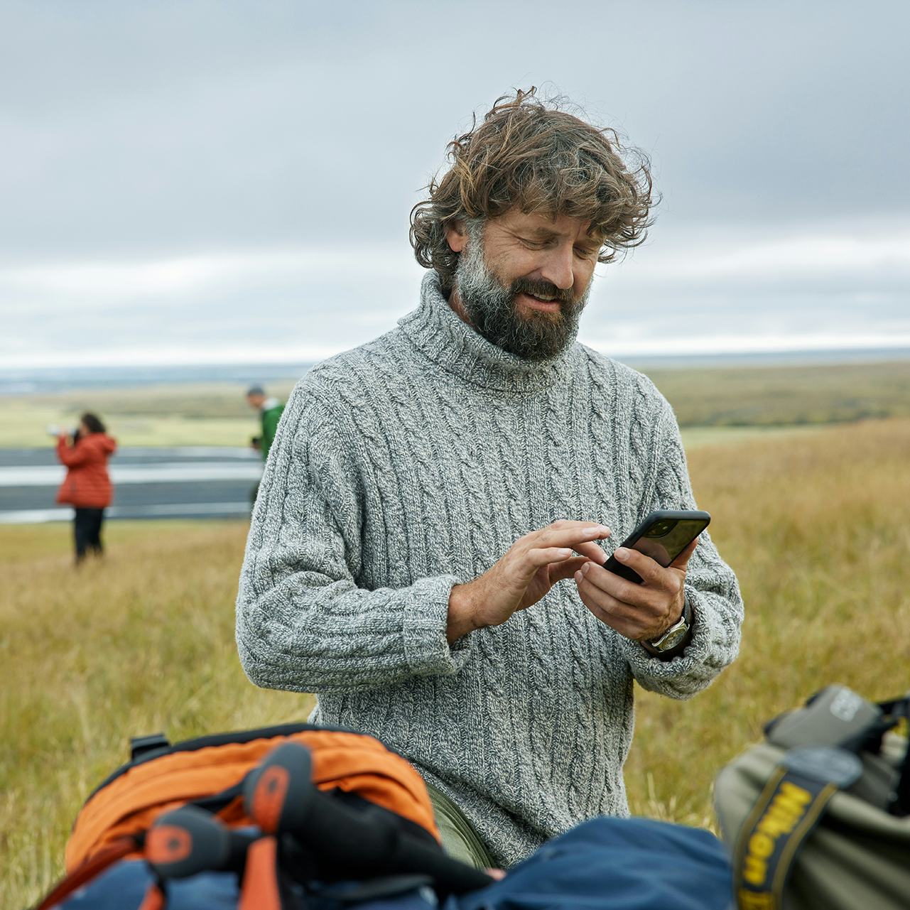 Maður með síma úti í náttúrunni