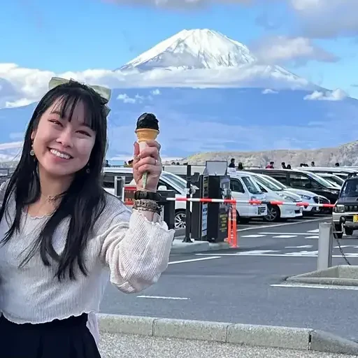 Portrait of Diane Phan, Developer Educator, holding an ice cream cone in front of Mt. Fuji and smiling.
