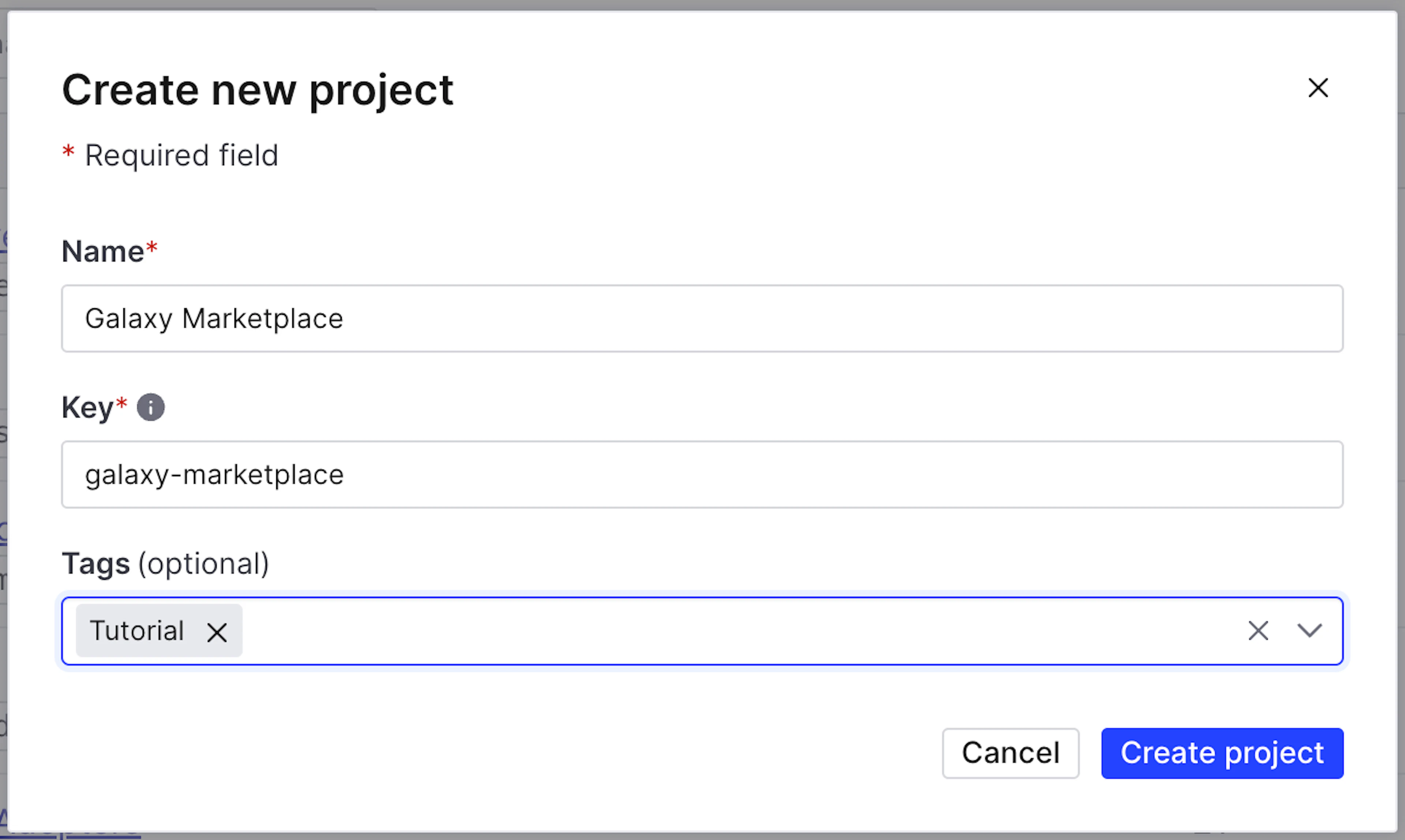 The image shows a modal dialog for creating a new project in LaunchDarkly. The details are as follows:

- Title: "Create new project"

- An asterisk indicates that the fields are required.

- Three fields to fill out:

  - **Name\***: "Galaxy Marketplace"

  - **Key\***: "galaxy-marketplace"

  - **Tags** (optional): "Tutorial"

- Two buttons at the bottom:

  - "Cancel" (left, with a white background)

  - "Create project" (right, with a blue background)

- A close button (X) at the top right corner of the dialog.