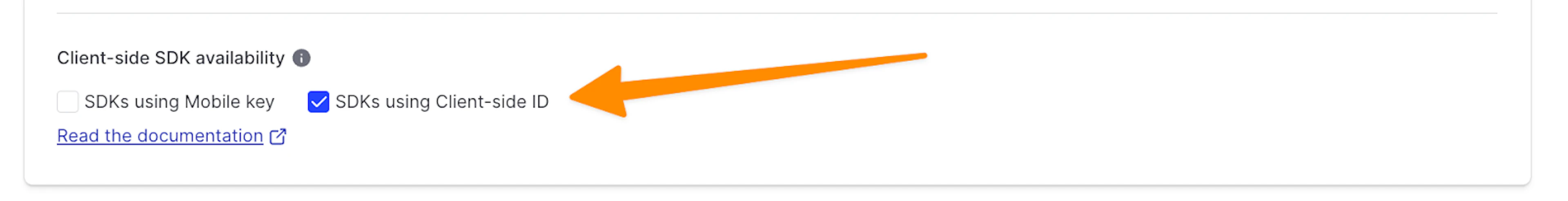Client-side SDK availability configuration screen in LaunchDarkly, with an orange arrow pointing to a checkbox for SDKs using the client-side ID.