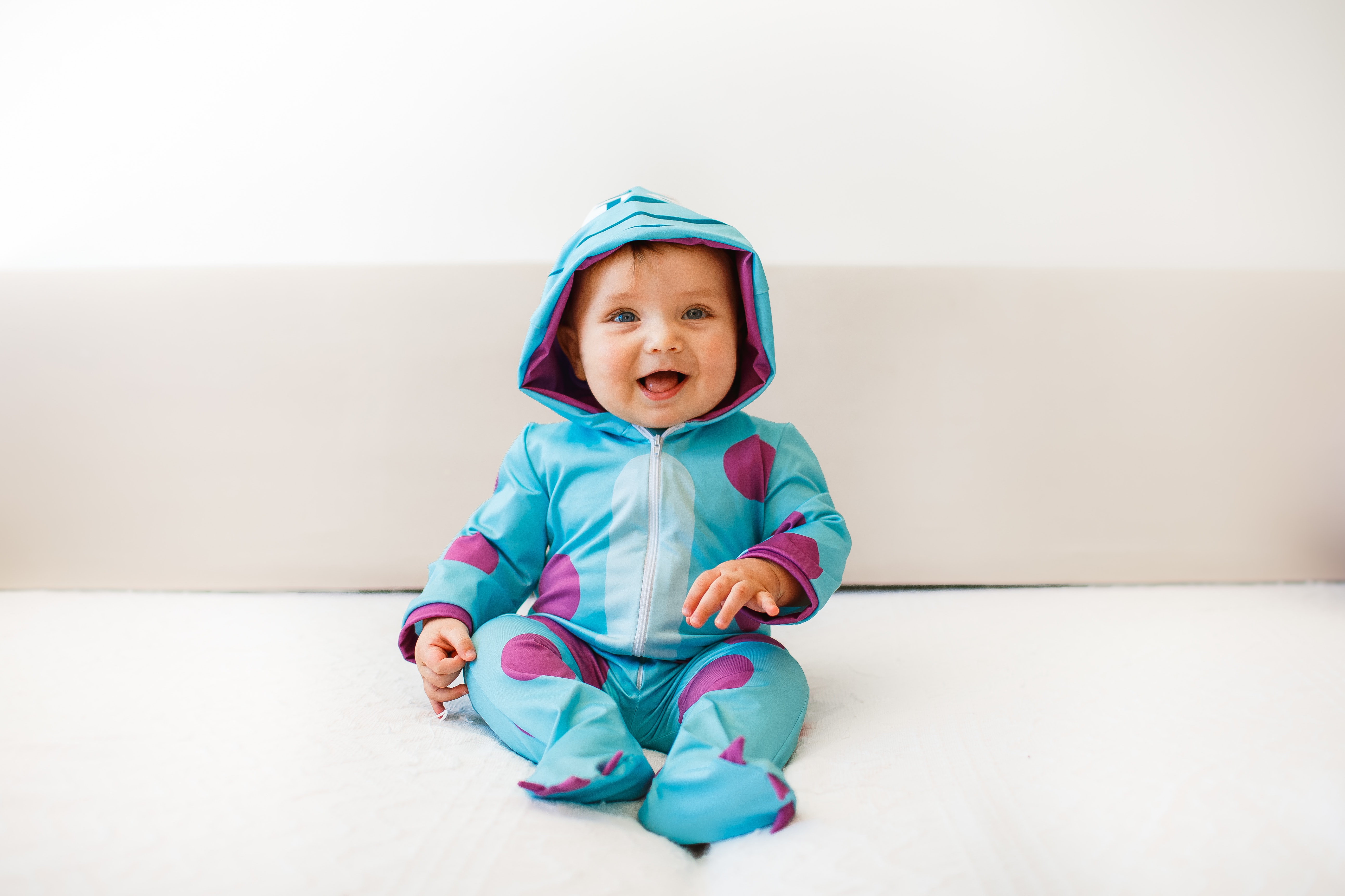 Smiling baby wearing footed pajamas