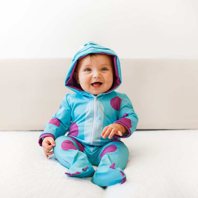 Smiling baby wearing footed pajamas