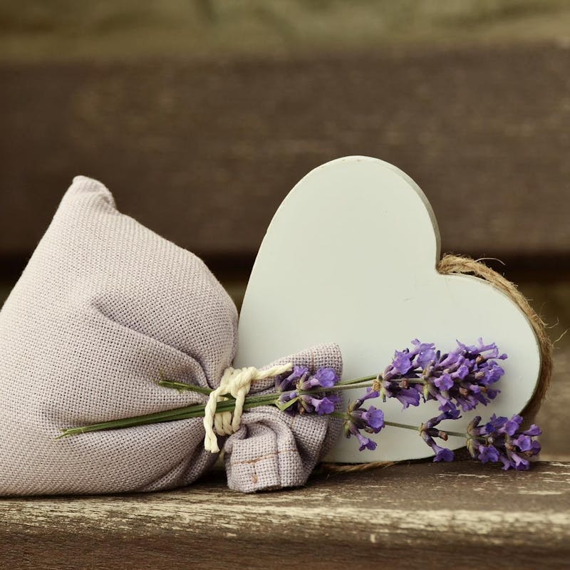 A lavender bag with a heart cutout beside it