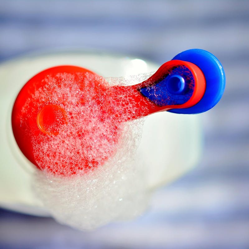 Bubbles coming out of a detergent bottle