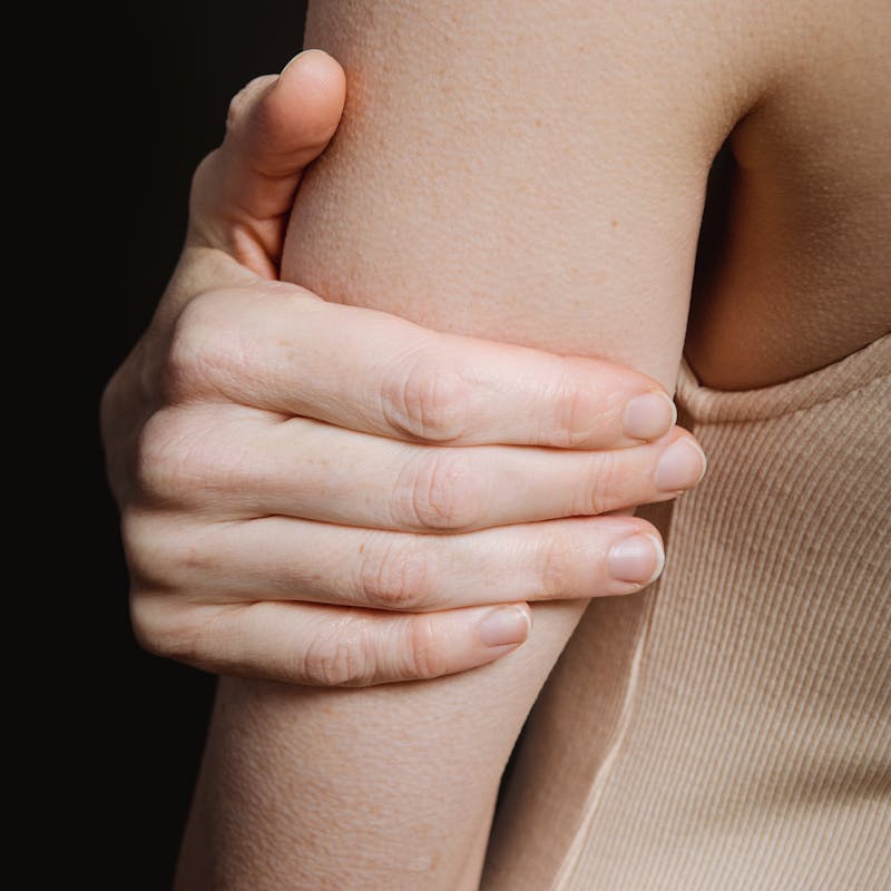 A person holding their arm