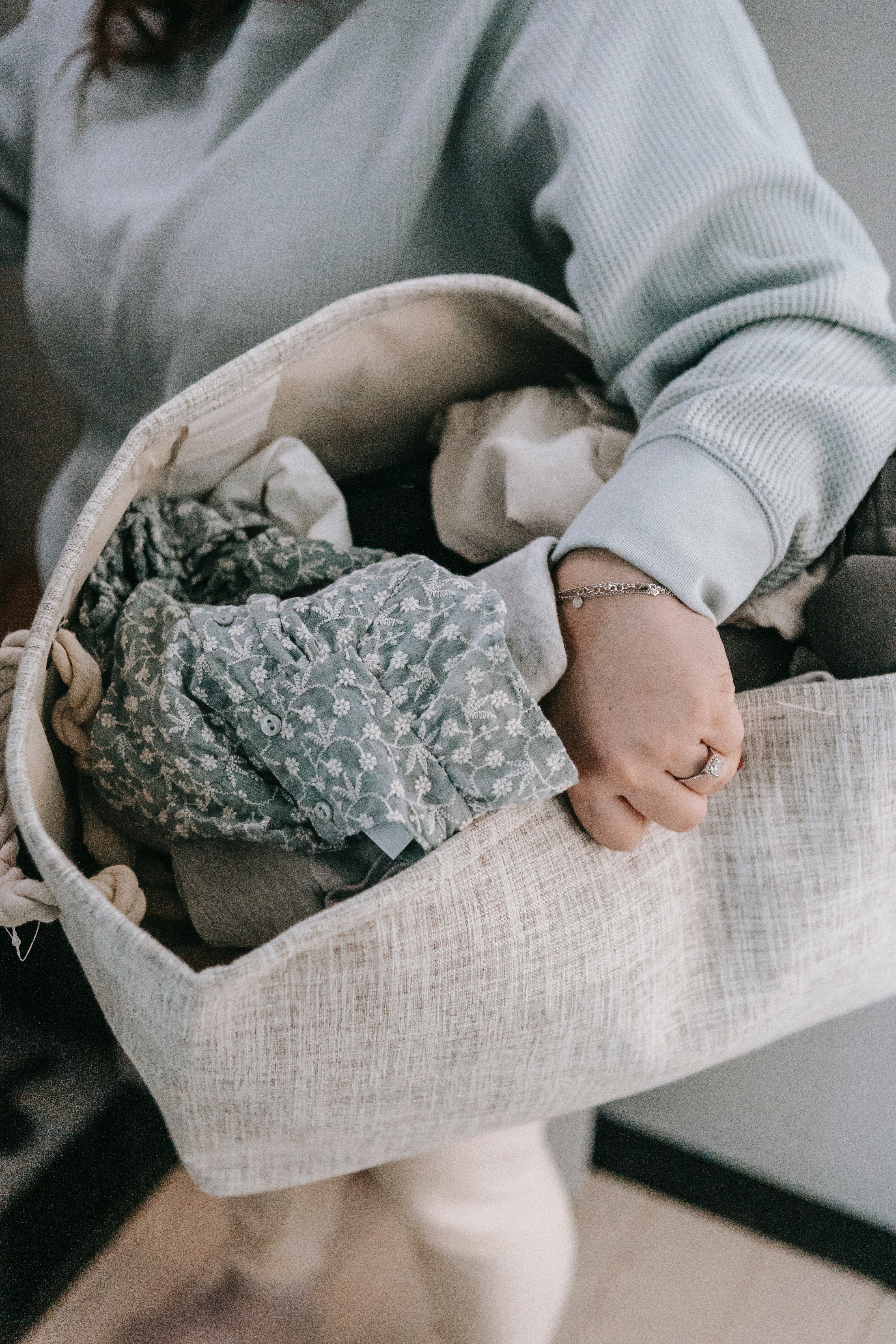 A woman holding a laundry basket full of clothes.