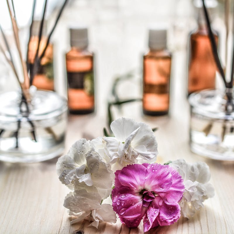 A flower with vials of oils around it