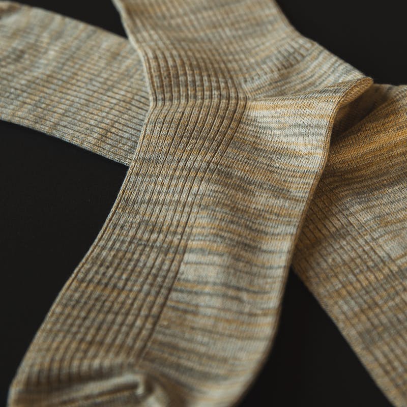 Grey socks on a black surface
